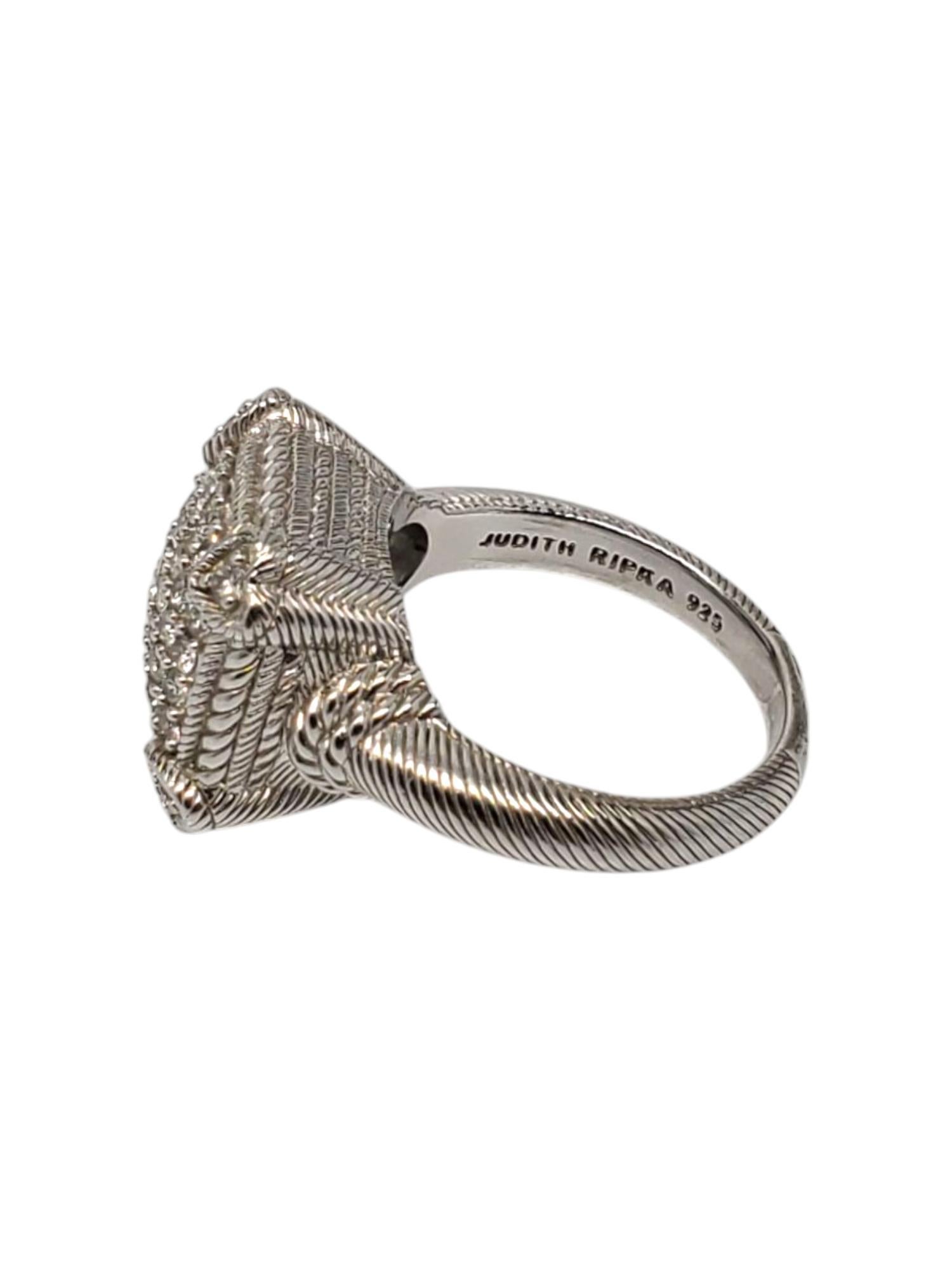 Judith Ripka Sterling Silver CZ Pave Ring Size 8

This elegant square ring features multiple CZ stones that are set in a pave setting with 4 corner heart accents in a textured sterling silver design by Judith Ripka.

Shank: 2.90 mm

Front of ring