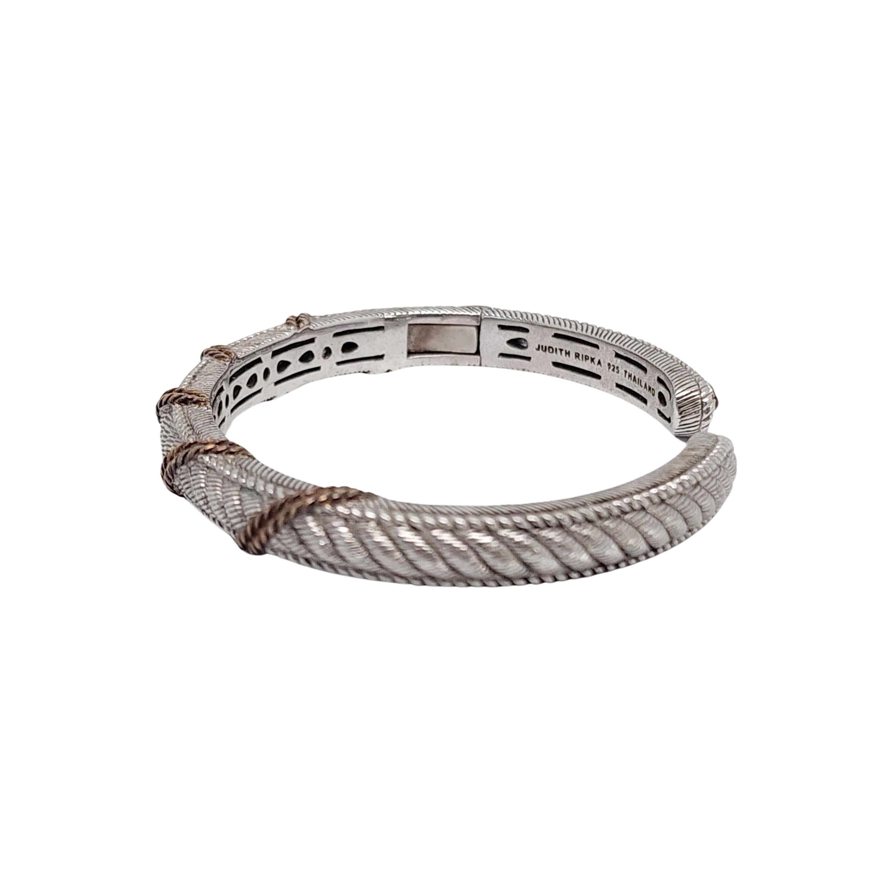 Judith Ripka sterling silver gold rope 2 tone hinged cuff bracelet

This bracelet features a textured sterling silver base with a gold tone rope accent. Hinged for ease of putting it on and taking it off.

Measures approx 5 1/2