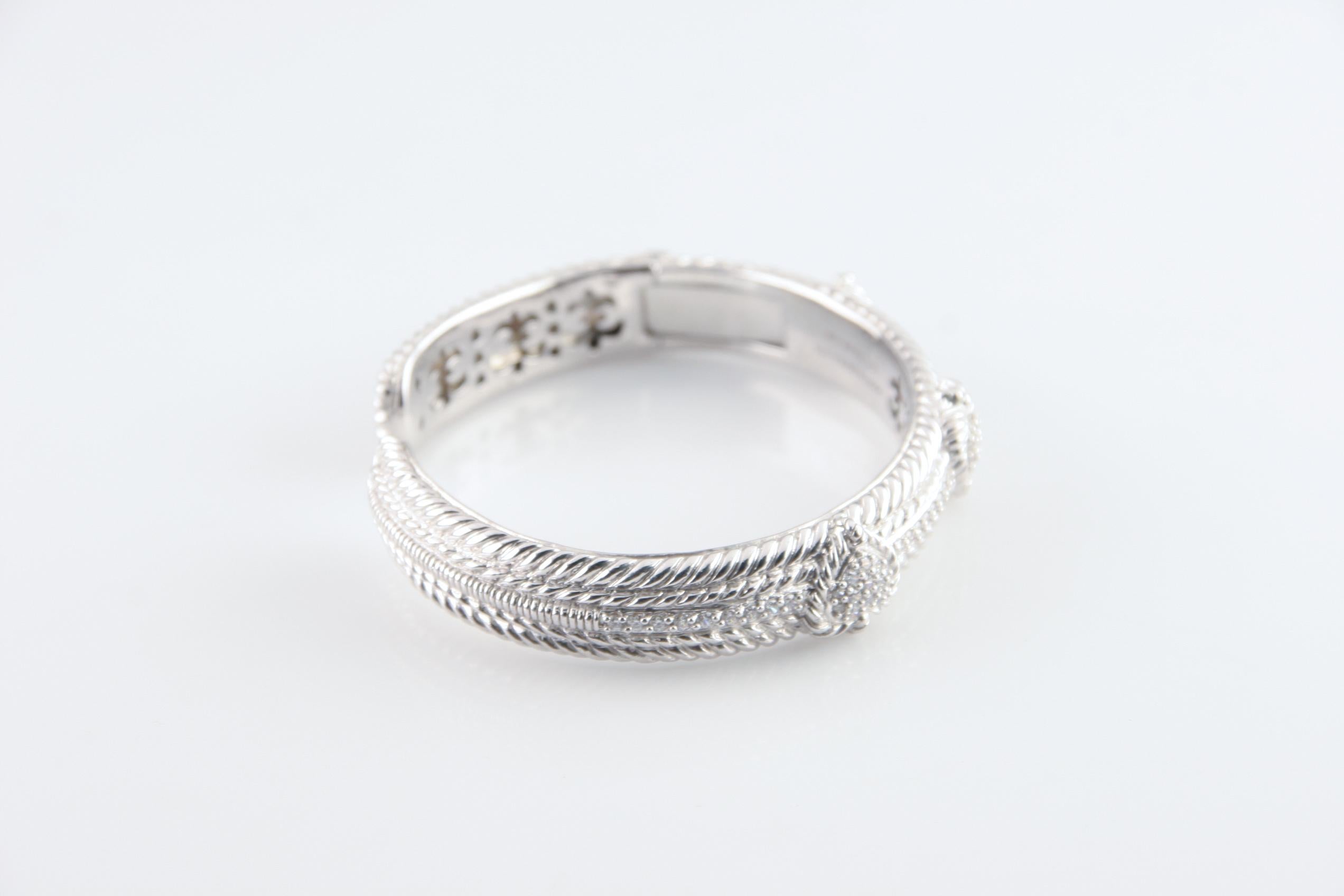 Gorgeous, large Judith Ripka hinged cuff bracelet.
Features pavé cubic zirconia (Diamoniques) hearts with other CZ accents.
Wrist Fit: 7 inches.
Outer Circumference: 8.75 inches.
Width: 11 mm.
Weight: 44.8 grams.
An amazing piece by an inimitable