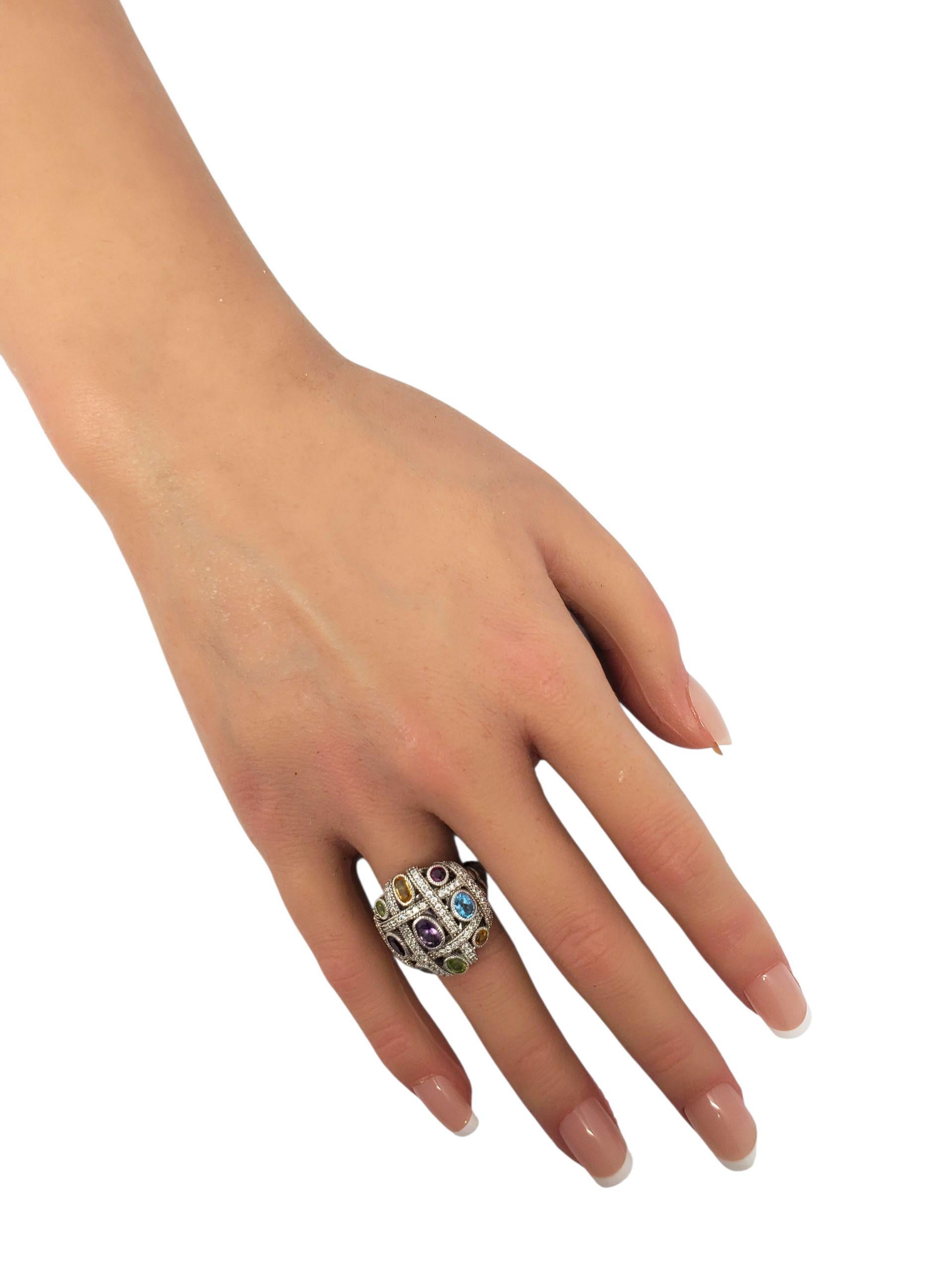 Judith Ripka Sterling Silver Multi Colored CZ Dome Ring.

This stunning Judith Ripka sterling silver dome ring features an array of multi colored bezel set CZ stones with a raised lattice and rope design.

Size: 6

22mm x 21mm x 7mm

Shank: 2.5