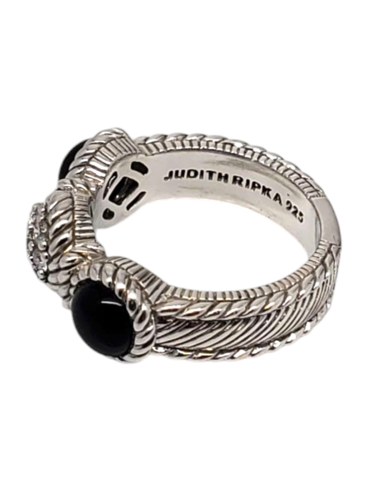 Judith Ripka Sterling Silver Onyx & CZ Ring -

This elegant ring features a CZ cluster center with 2 round cabochon onyx accent stones set in a sterling silver rope and textured design by Judith Ripka.

Shank: 5 mm

Front of ring approx. 8 mm x 23