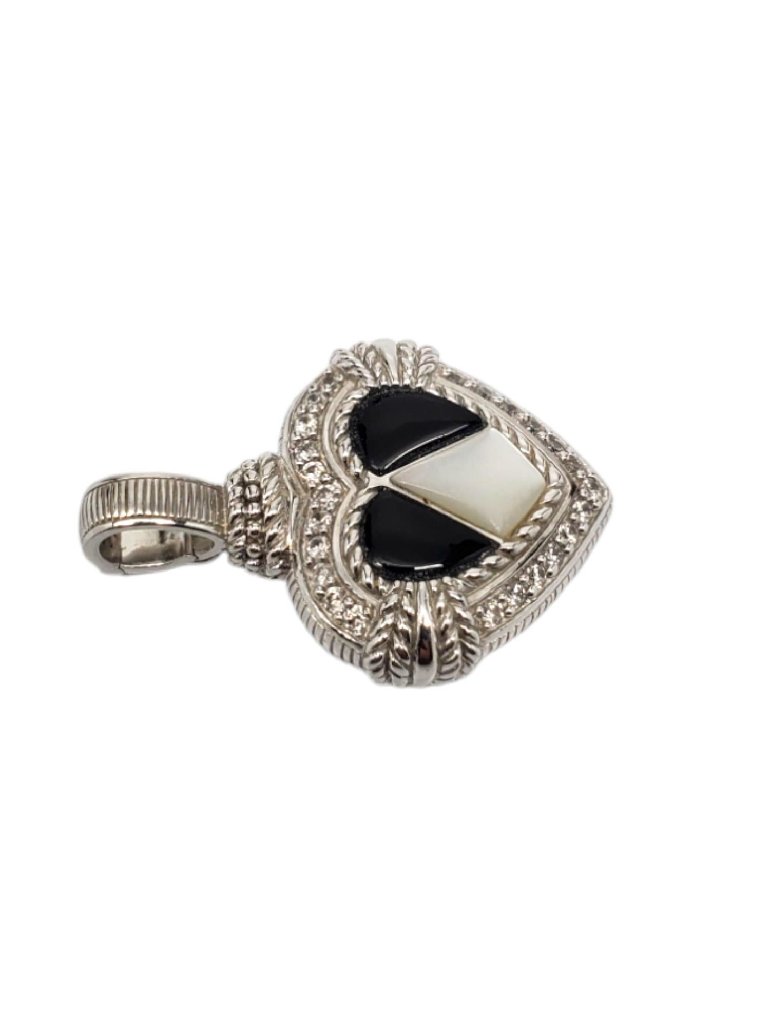 Judith Ripka Sterling Silver Onyx & Mother Of Pearl Heart Pendant-

This beautiful heart pendant by Judith Ripka features onyx and mother of pearl center with cz accents set in sterling silver with enhancer.

Size: 37.15 mm. with bail.

Stamped: