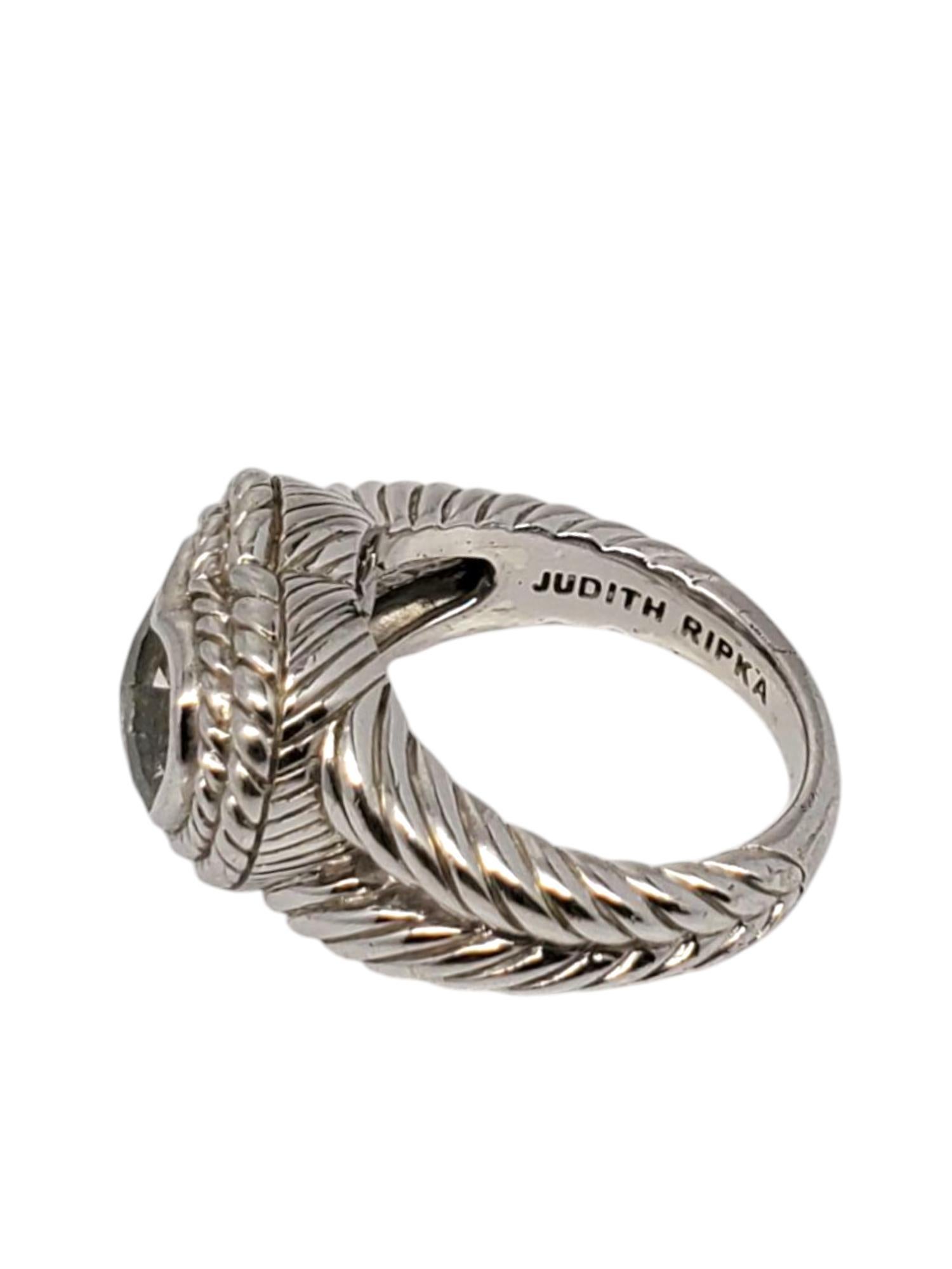 Judith Ripka Sterling Silver Prasiolite Heart Ring -

This beautiful ring by Judith Ripka features a large heart shaped green prasiolite (8 mm X 10 mm) surrounded by a rope design set in sterling silver.

Shank: 3 mm

Front of ring approx. 15 mm x