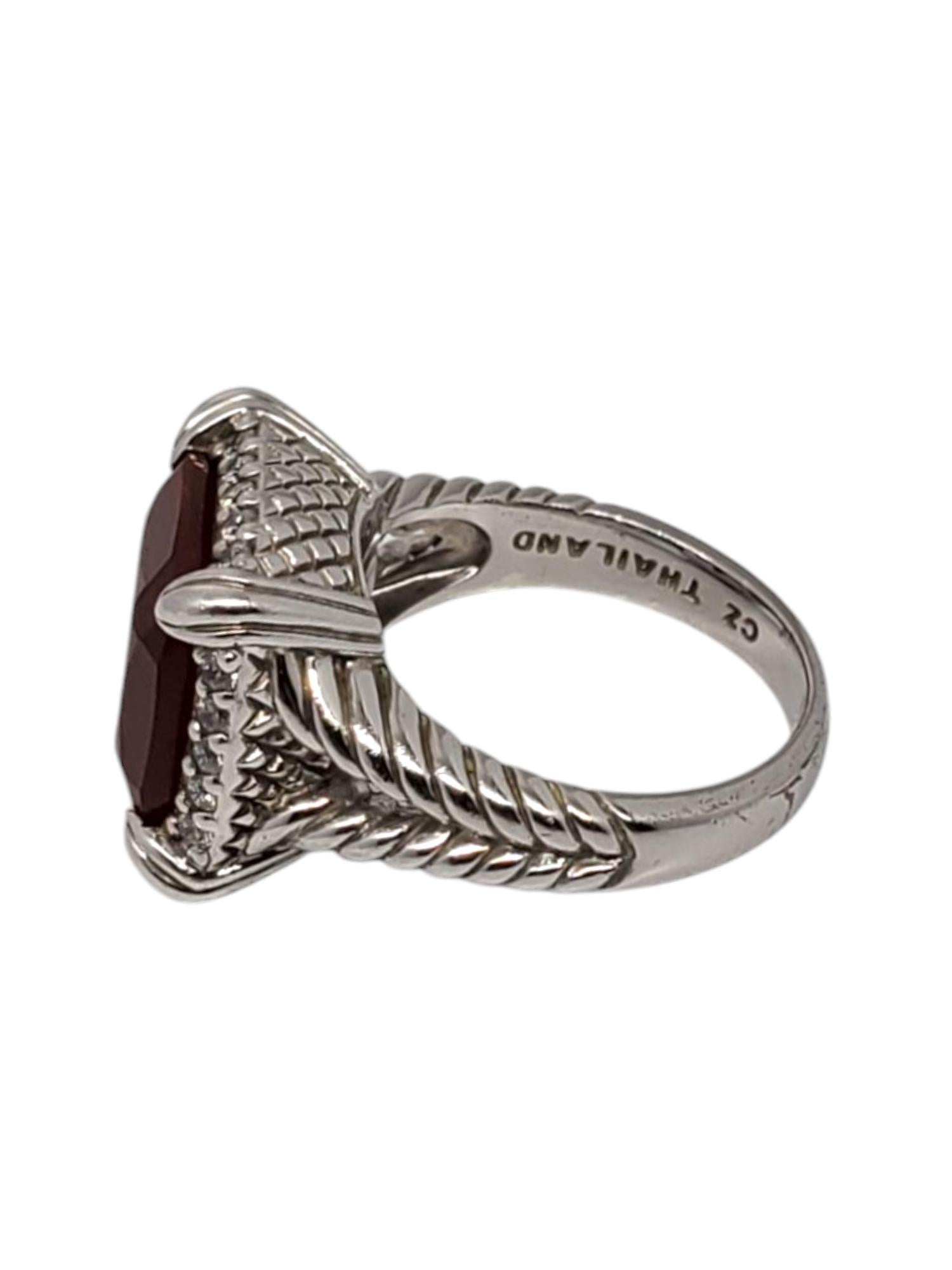 Judith Ripka Sterling Silver Red Carnelian & CZ Ring -

This vintage ring by Judith Ripka features a large red carnelian gemstone (12 mm x 12 mm) surrounded by CZ accent stones set in a sterling silver rope design.

Shank: 3 mm

Front of ring