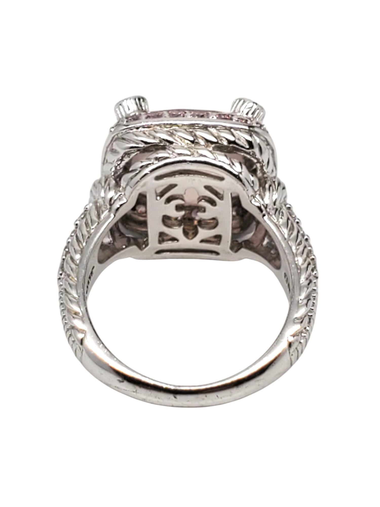 Judith Ripka Sterling Silver Rose Quartz & CZ Ring 

This beautiful ring by Judith Ripka features a large cushion cut rose quartz (12 mm x 12 mm) surrounded by pink & colorless CZ set in a sterling silver and textured band.

Shank: 3 mm

Front of
