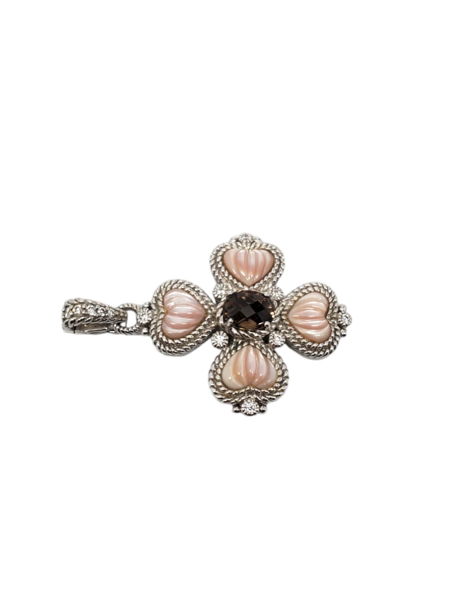 Judith Ripka Sterling Silver Smokey Quartz Mother of Pearl & CZ Pendant Enhancer

This glowing Judith Ripka pendant features a smokey quartz (8.45mm x 7.19mm) center & carved mother of pearl with cz accents.

Size: 50.00mm with bail.

Stamped: