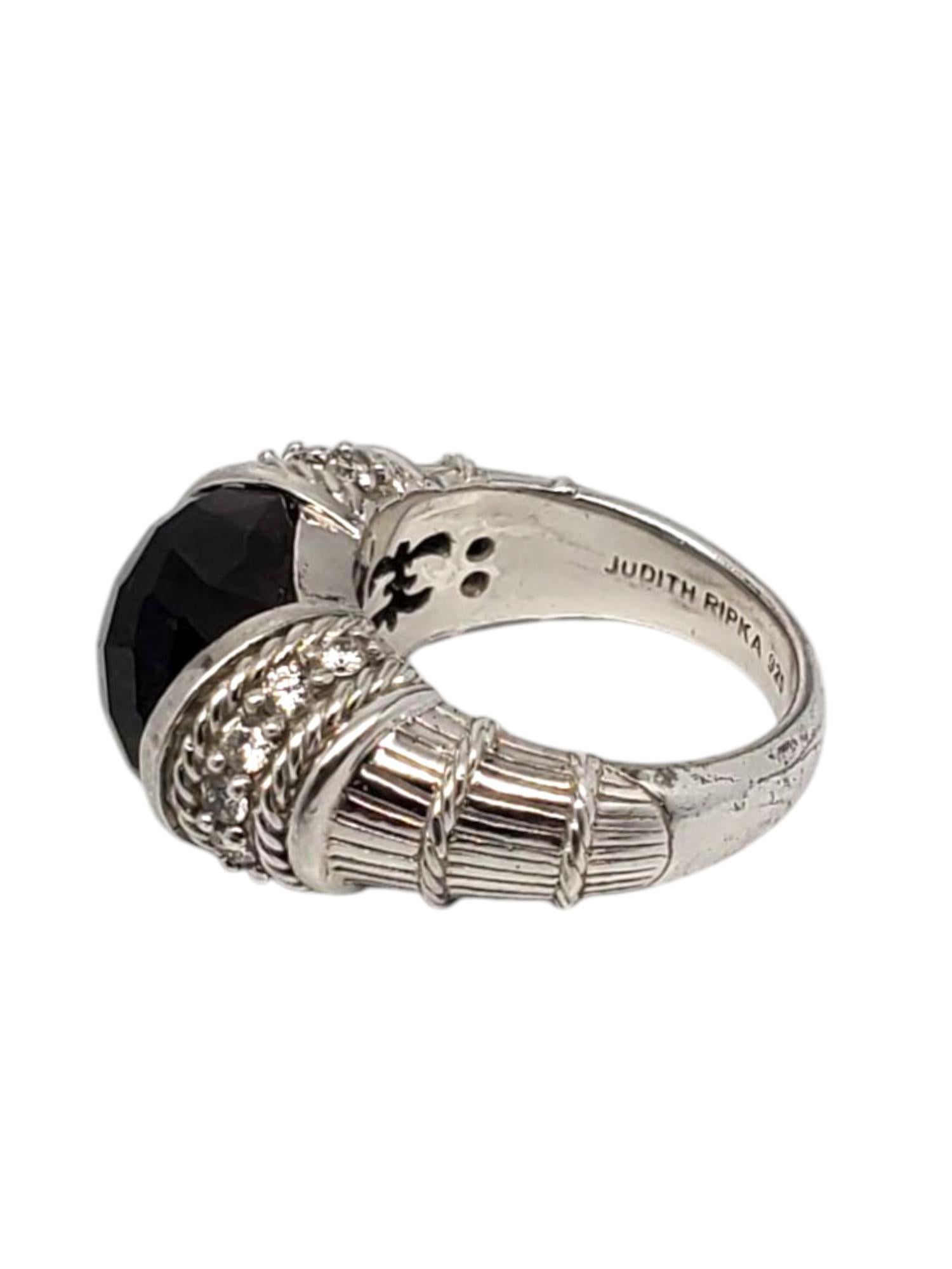 Judith Ripka Sterling Silver Smokey Topaz & CZ Ring -

This stunning ring features a large faceted smokey topaz (10 mm x 12.5 mm) with CZ accent stones set in a sterling silver textured design by Judith Ripka.

Shank: 4 mm

Front of ring approx. 10