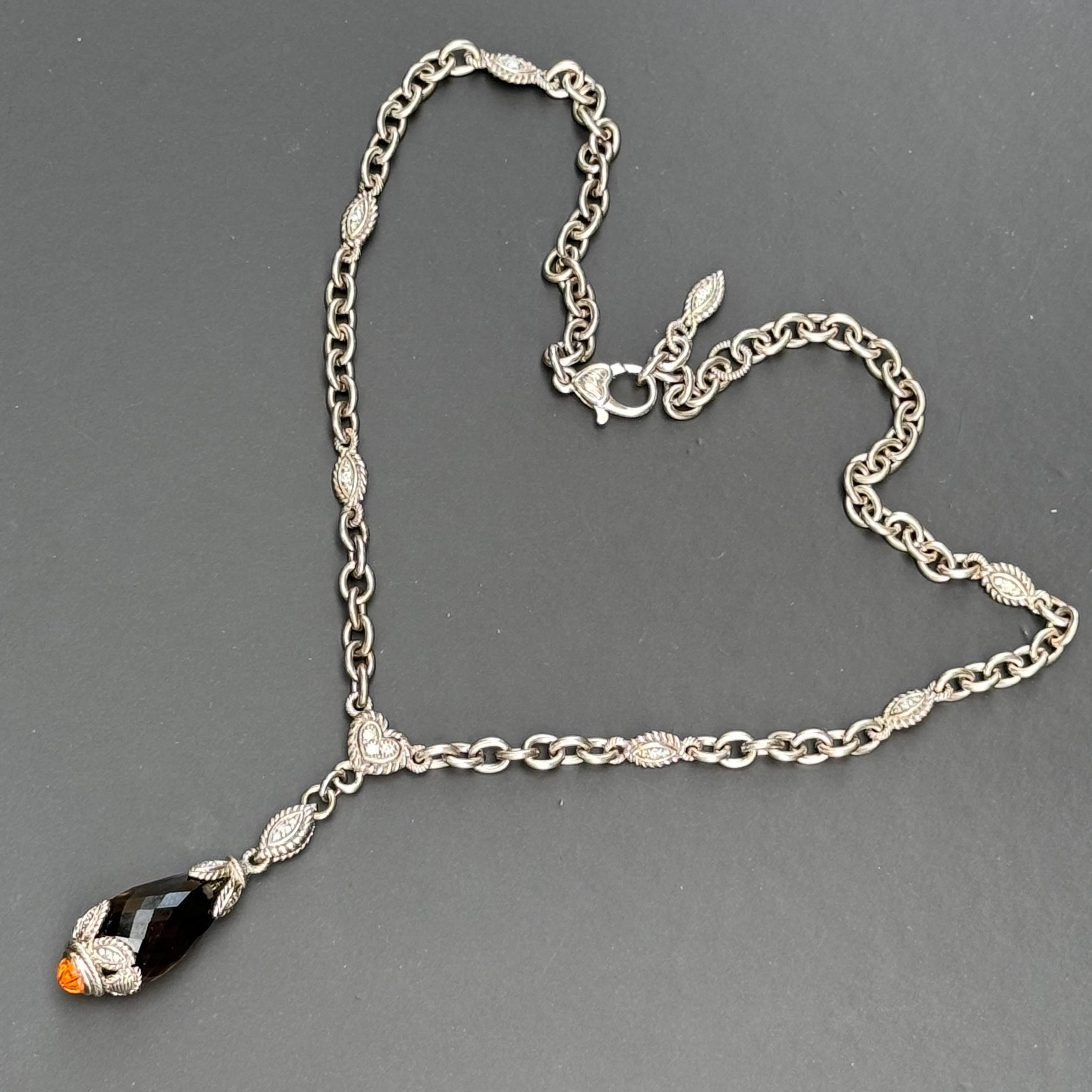 Designer: Judith Ripka
Material: solid sterling silver , Faceted Smoky Quartz with  carved Citrine Cap . Chain has CZ Diamoniques throughout chain.
Dimensions: necklace measures 19 1/2 inches 
Pendant adds 2 1/2 inches in total drop length x 5/8