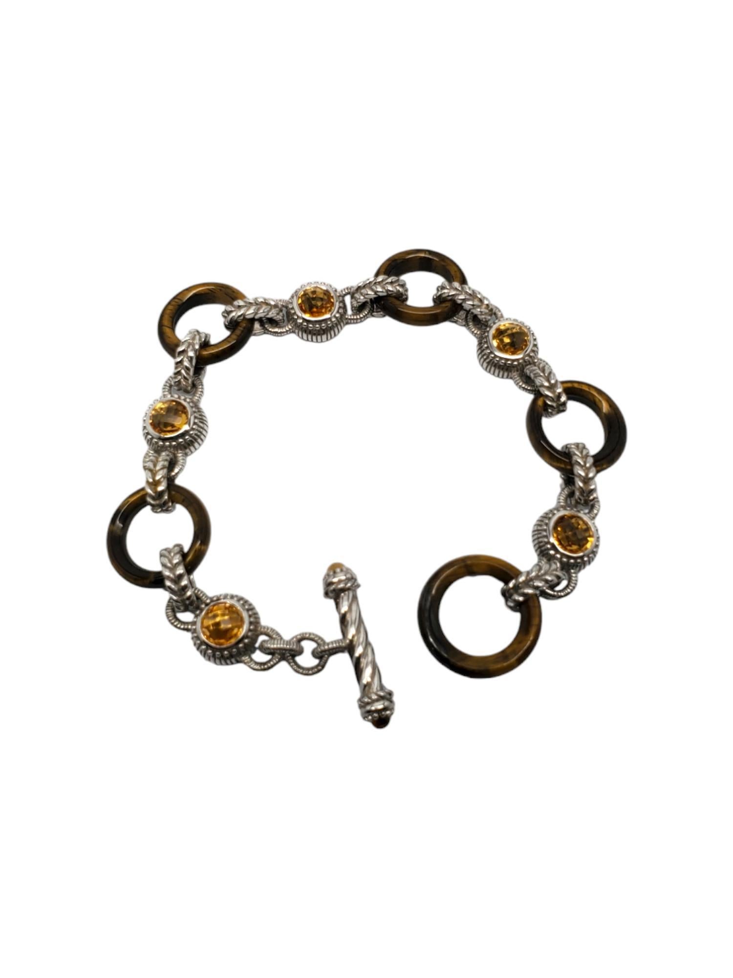 Judith Ripka Sterling Silver Tigers Eye & Citrine Cable Toggle Bracelet -

This unique toggle bracelet features tigers eye & 5 round citrine stones set in sterling silver cable design by Judith Ripka.

Size: Fits up to 6 3/4