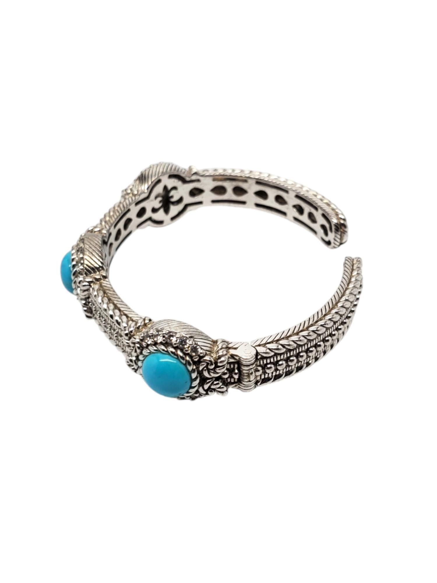 Judith Ripka Sterling Silver Turquoise CZ Hinged Cuff Bracelet

This vintage hinged cuff bracelet by Judith Ripka features 3 round turquoise stones (9.25mm) with CZ accents set in sterling silver.

Size: 7 in. in circumference around inside of