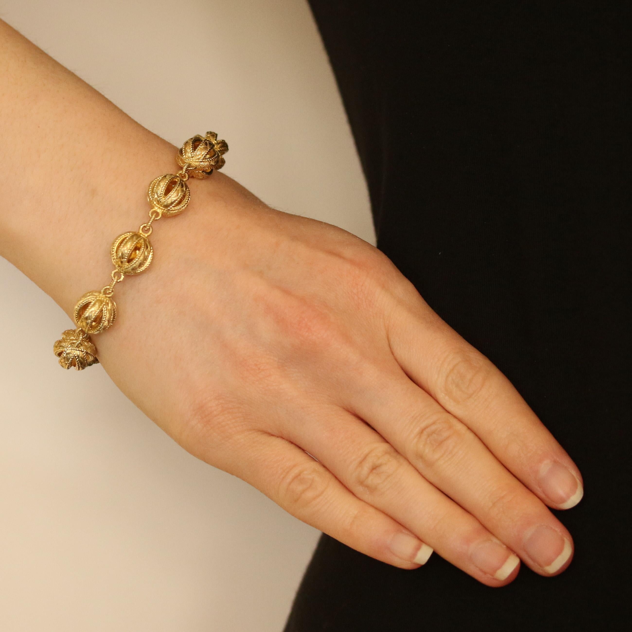 Surprise a special friend or family member with this gorgeous designer bracelet! Fashioned by Judith Ripka in gold-plated sterling silver, this eye-catching piece features nine large, open-cut beads. Ribbed designs and roped detailing give the