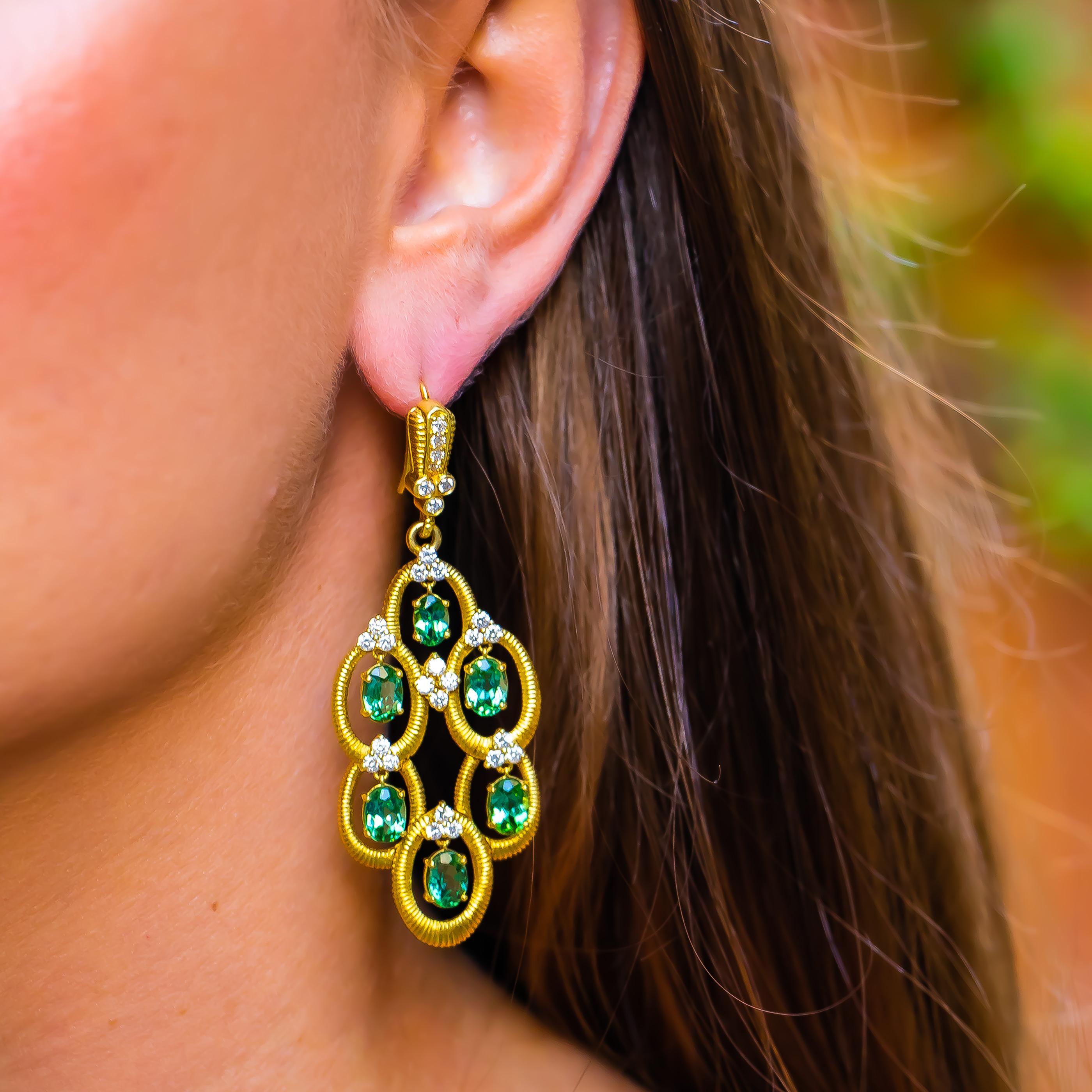 Beautiful 18K Yellow Gold Earrings with over 10 carats of Tourmalines. These earrings effortlessly round off any Elegant Evening Gown. 
Tourmaline = 10.5 carats
Diamonds = 1.8 carats
( Color: F, Clarity: VS )
18K Yellow Gold
Signed Judith