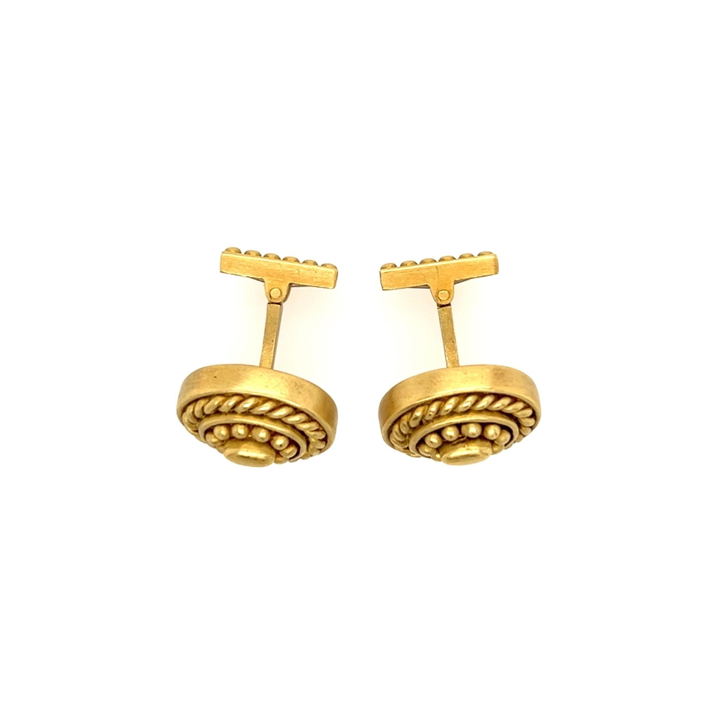 A pair of 18 karat yellow gold cufflinks. Judith Ripka. Designed as a matte ropework and beaded oval plaque, joined by a bar to a swivel link. Length is approximately 5/8 inches, gross weight is approximately 28.3 grams.