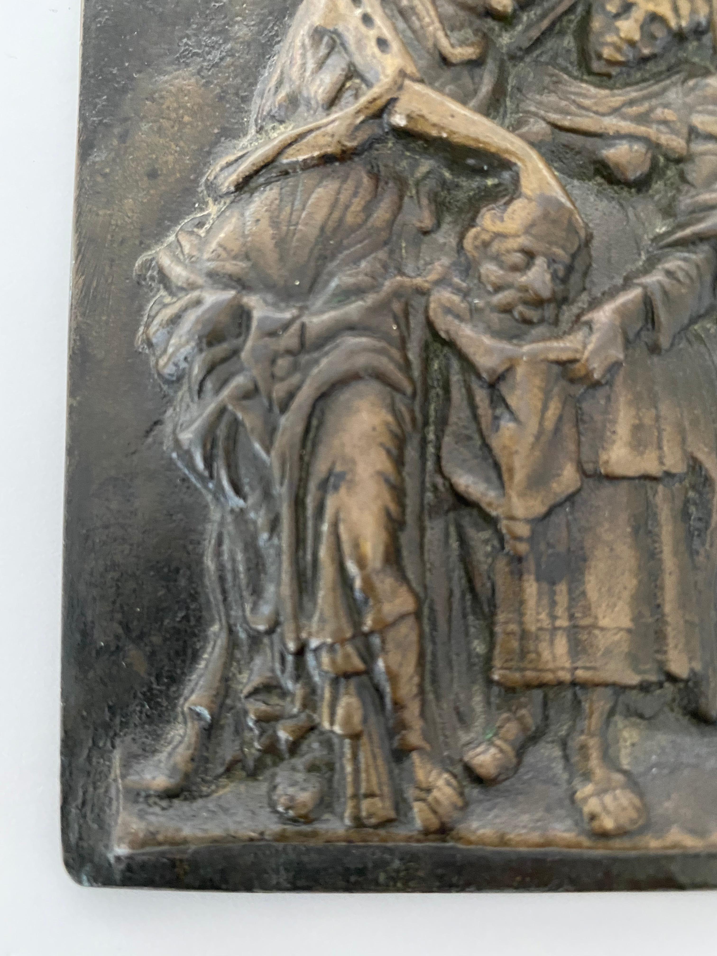 Judith with the head of Holofernes, unsigned rectangular cast bronze plaquette, by Andrea Briosco, called Riccio (1470-1532), Judith standing at left, her leg forward leans with head of Holofernes to place it in a sack held open by her servant
