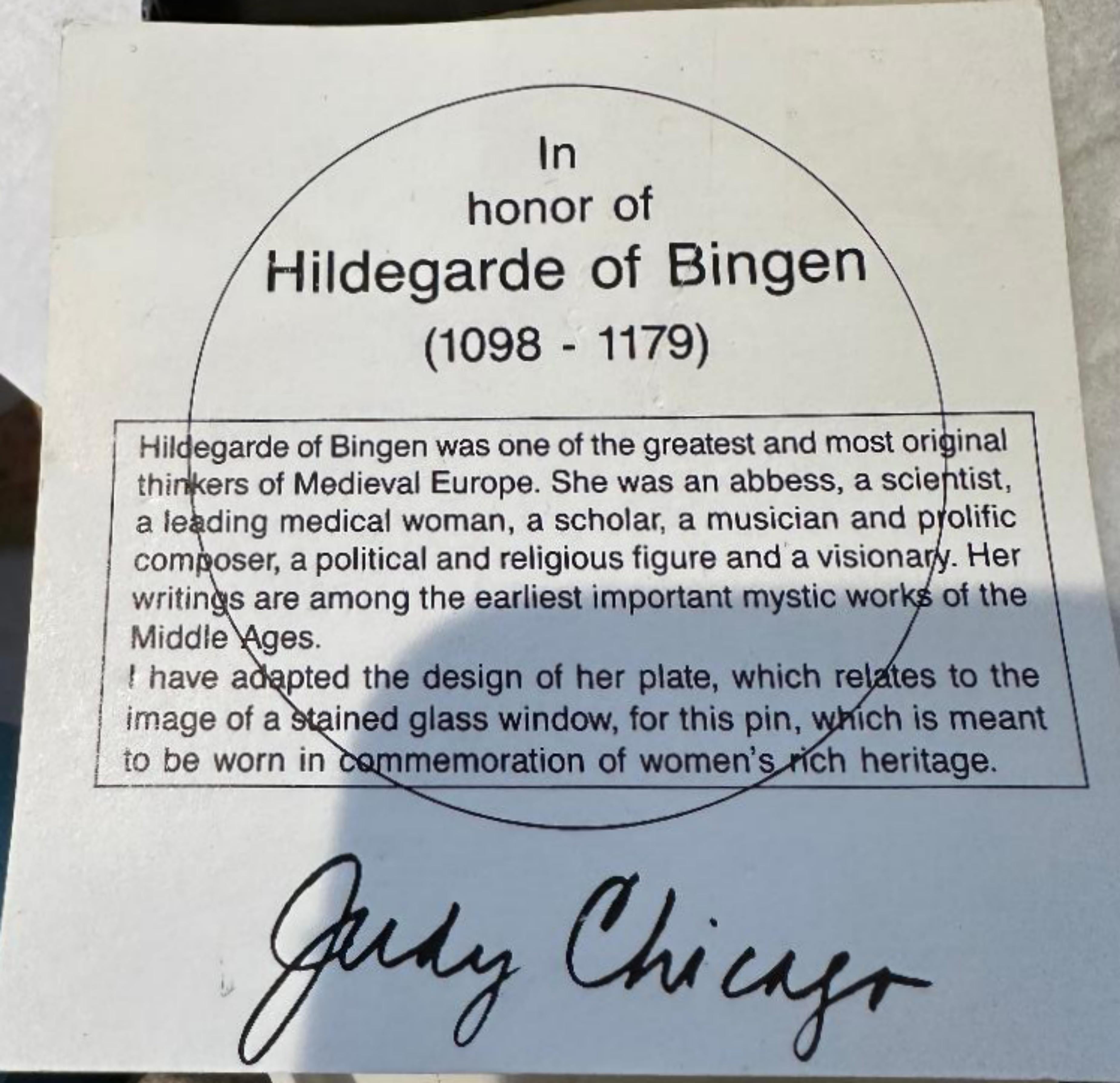 Judy Chicago
Cloisonne Brooch of Hildegard of Bingen from The Dinner Party, 1987
Cloisonne brooch/pin with clasp on the back and Judy Chicago's incised signature and copyright
2 in diameter
Artist's incised signature, date and copyright incised on
