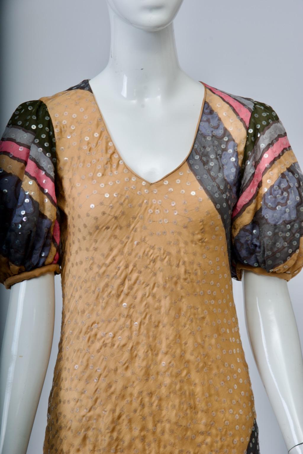 Judy Hornby multicolor silk print dress featuring a bias cut, double-tiered handkerchief hem, a deep V-neckline, and puffed sleeves. The British-born designer made her way to the United States in 1975 and became known for her evening wear, mostly