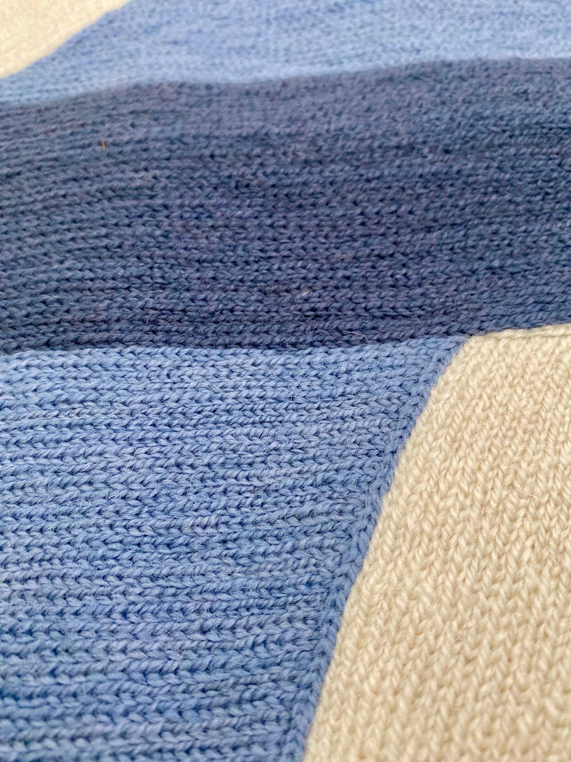 Judy Ross is a New York based designer and artist. Traveling in India to work as an independent textile designer, she developed a passion for the centuries-old hand embroidery technique known as chain stitch, used by men in the Kashmir region to