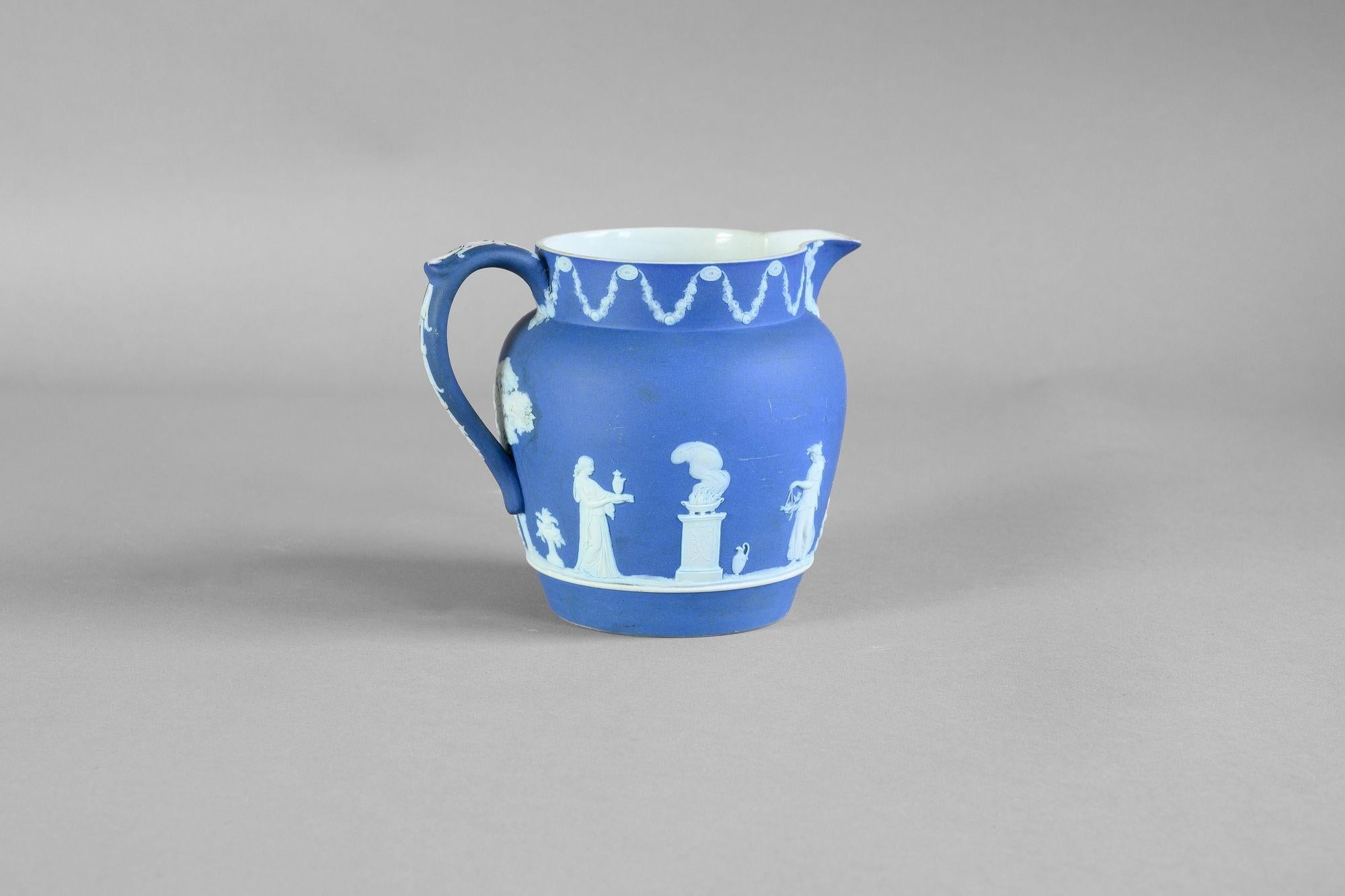 Wedgewood milk jug with classical decorated frieze. Circa 1880
H 13cm x W 13cm x D 17cm