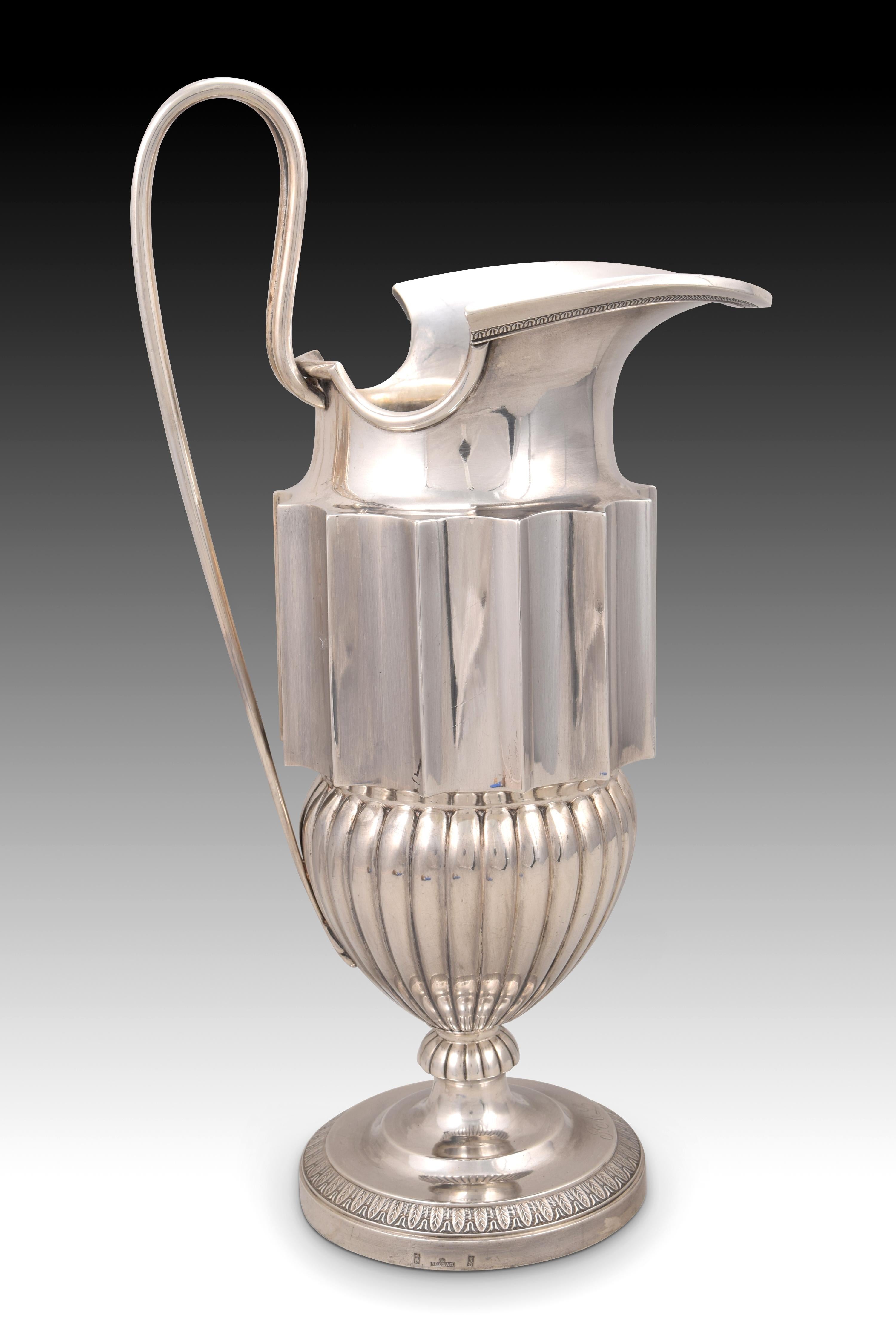 Jug. Silver. SELLAN, Juan. Madrid, 1847. 
With contrast markings. 
Silver pitcher in its color that has a flat handle decorated with simple openwork plant elements between two smooth bands and an upward shape, a large mouth extended forward, and a