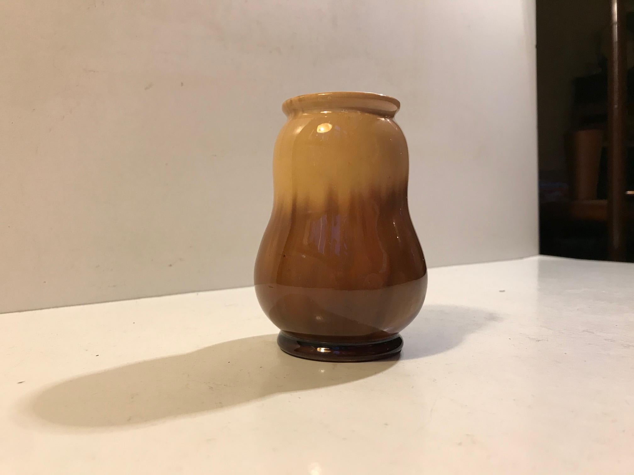 Small and early Danish Pottery vase with subtle Art Nouveau/Jugend styling and shape. Unusual caramel colored glazes. Designed by Michael Andersen & Son in Denmark between 1910-1920.