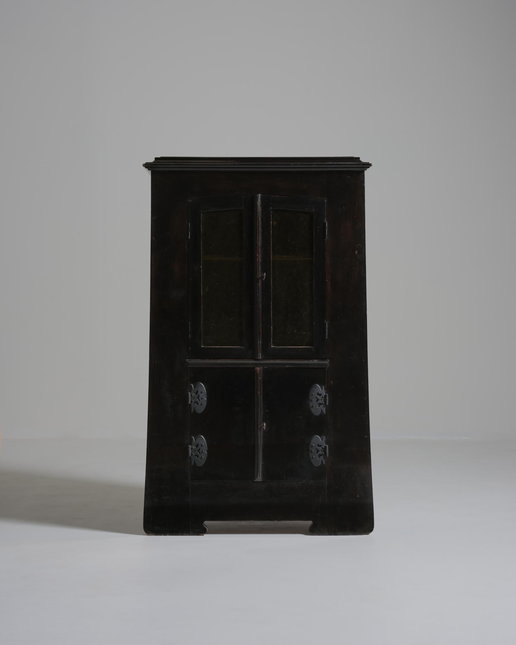 Small cabinet in blackened pearwood, Japanese-inspired from the Jugendstil period. Made in Germany circa 1910s.

Retains original stained glass doors, two interior shelves and two keys for locks.