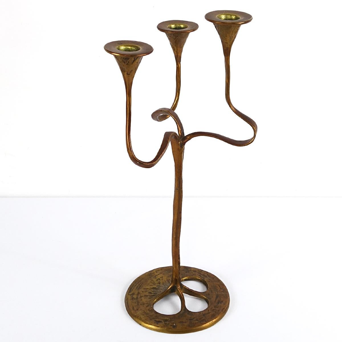 Very decorative candleholder made of brass carrying three candles on different heights.
The organically shaped Jugendstil candlestick reminds us of the typical Gaudí style with its natural forms and lines.
It was made by German metal specialist