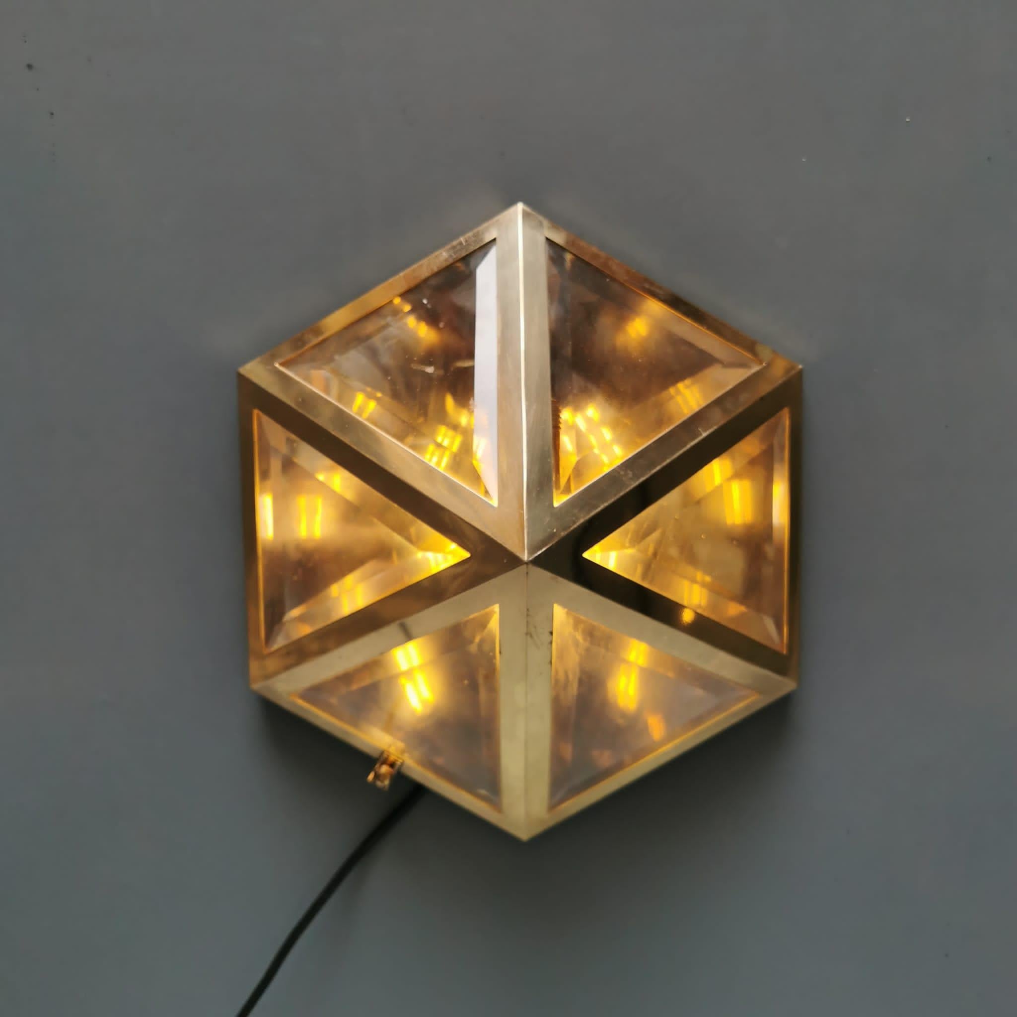 Brass and faceted transparent glass wall lamp designed in 1903 by Josef Hoffmann, Austrian architect and designer, among the founders of the Viennese secession, a lamp that was published and produced in the 1970s in Austria. A brass wall lamp with 6