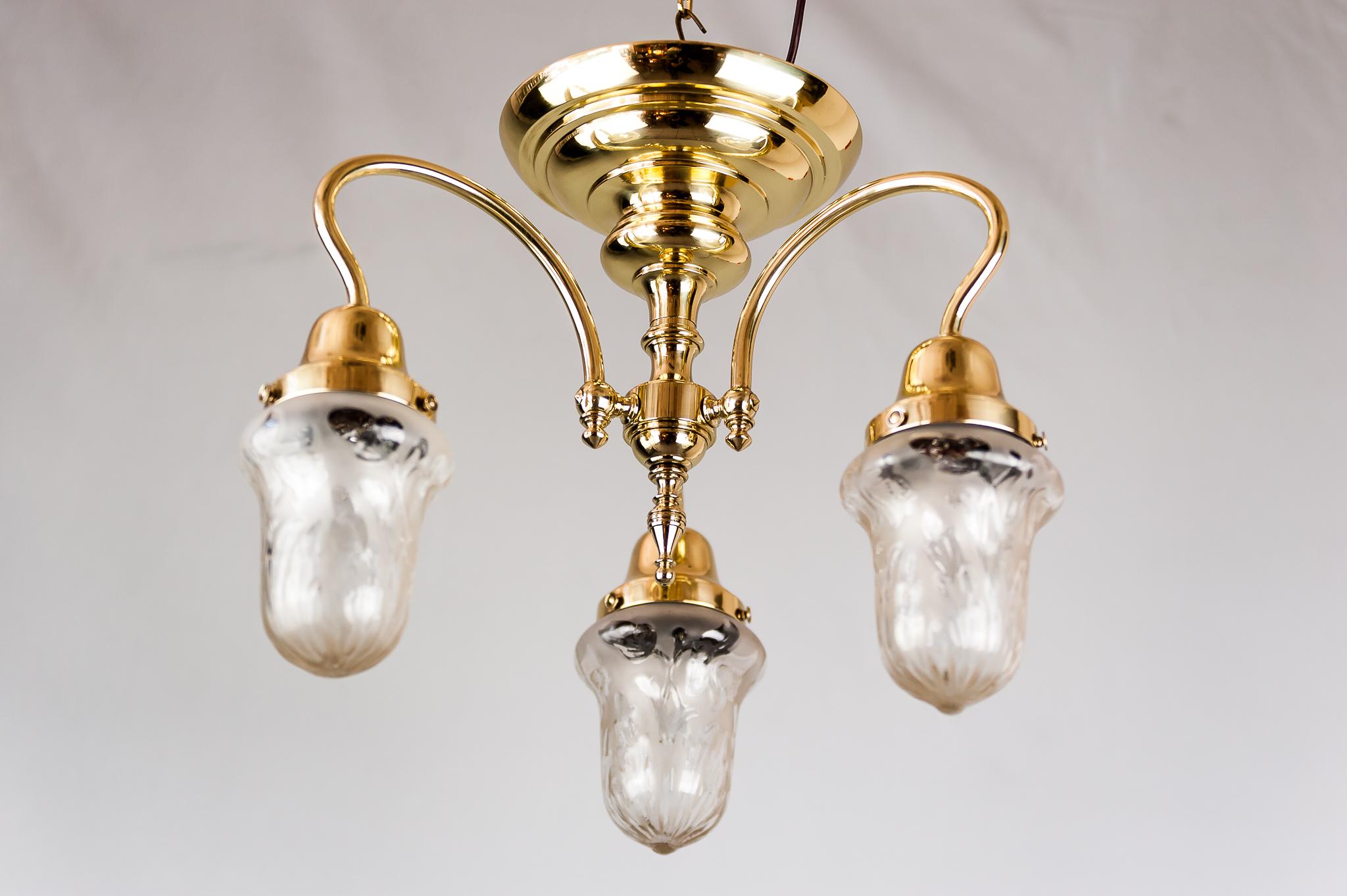 Jugendstil ceiling lamp, circa 1908 with original glass shades.
Polished and stove enameled.
 