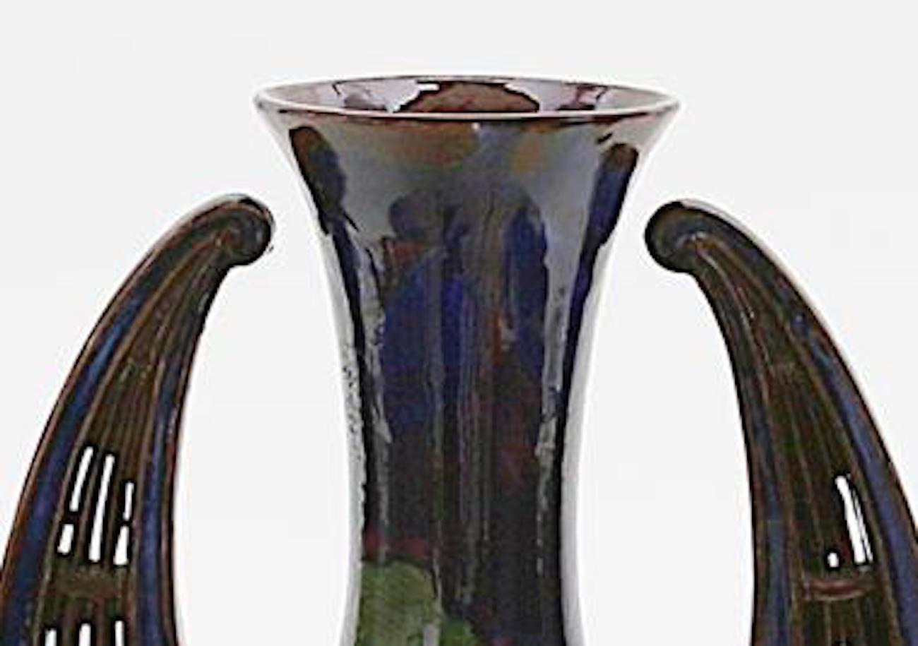 Jugendstil ceramic vase is an original decorative object realized in the 20th century. 

Original ceramic vase with burgundy red and cobalt blue glaze. All around colorful, stylized flower painting. 

On the base 