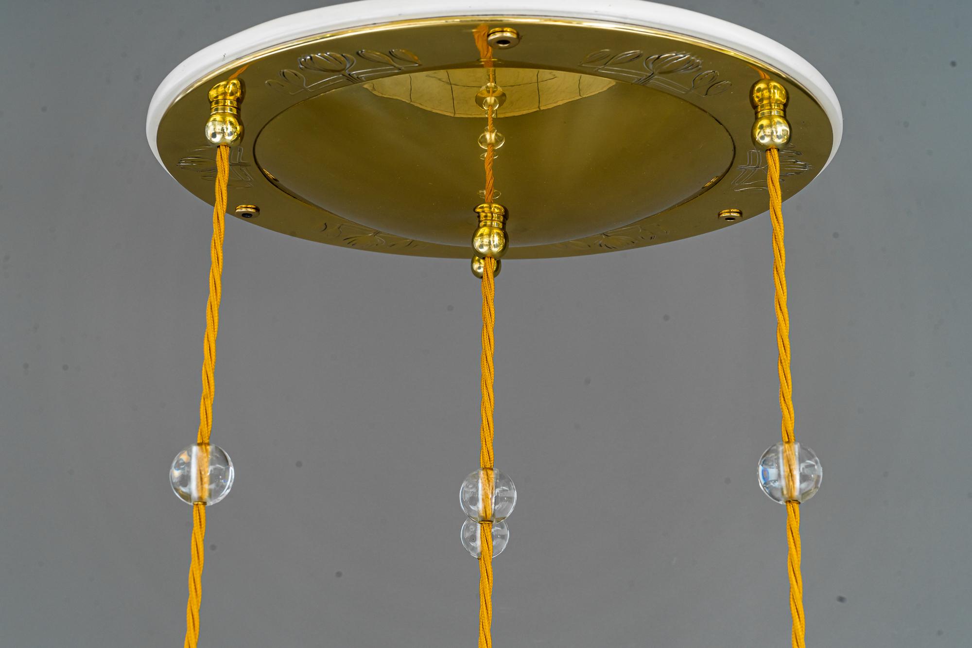Jugendstil chandelier vienna around 1910.
Brass polished and stover enameled.
We can adjust the height of the chandelier to your room height.
The wires are replaced (new).
The glass balls on the wire are replaced (new).
 