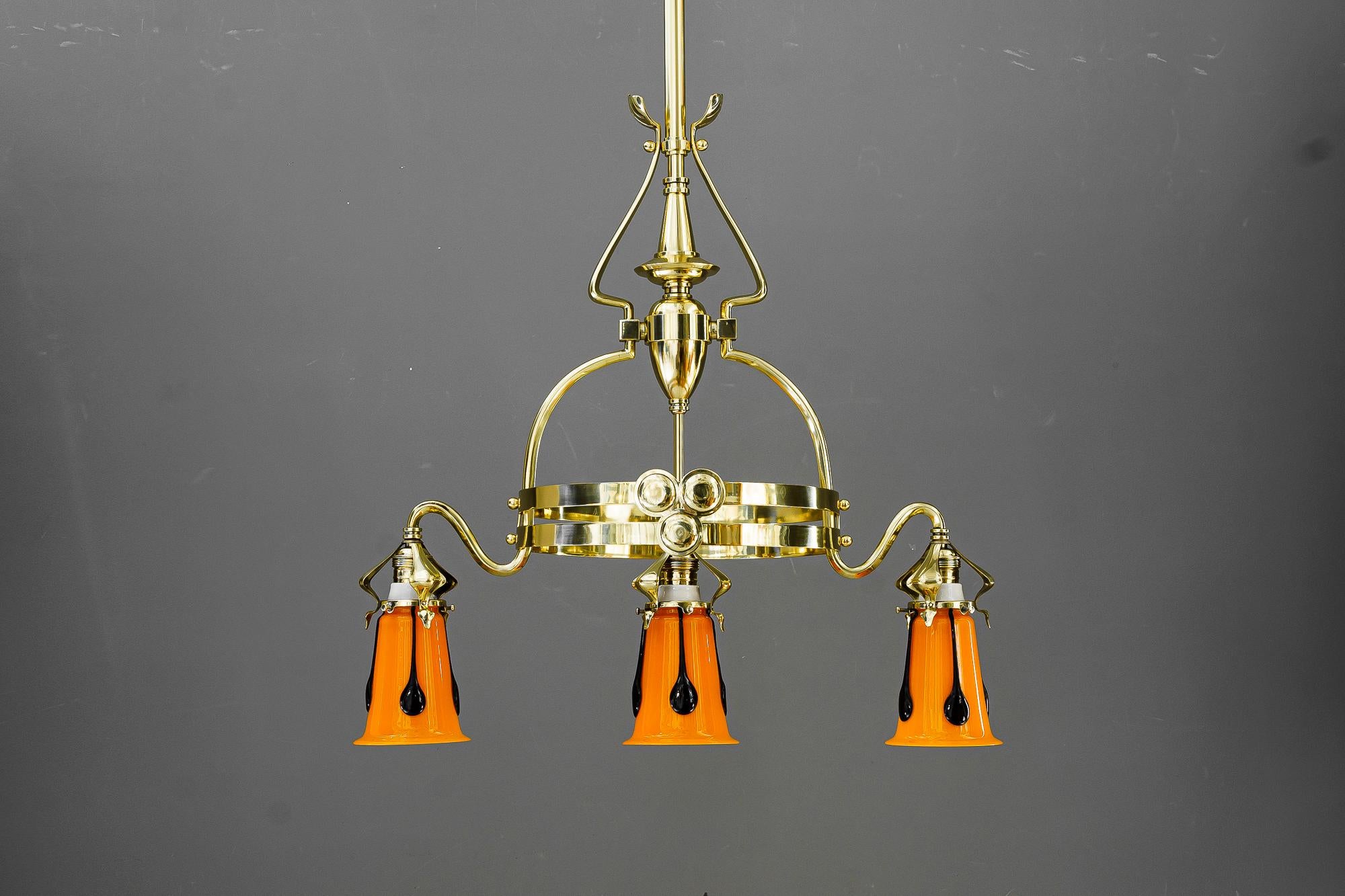 Jugendstil chandelier with loetz glass shades vienna around 1910
Brass polished and stove enameled
