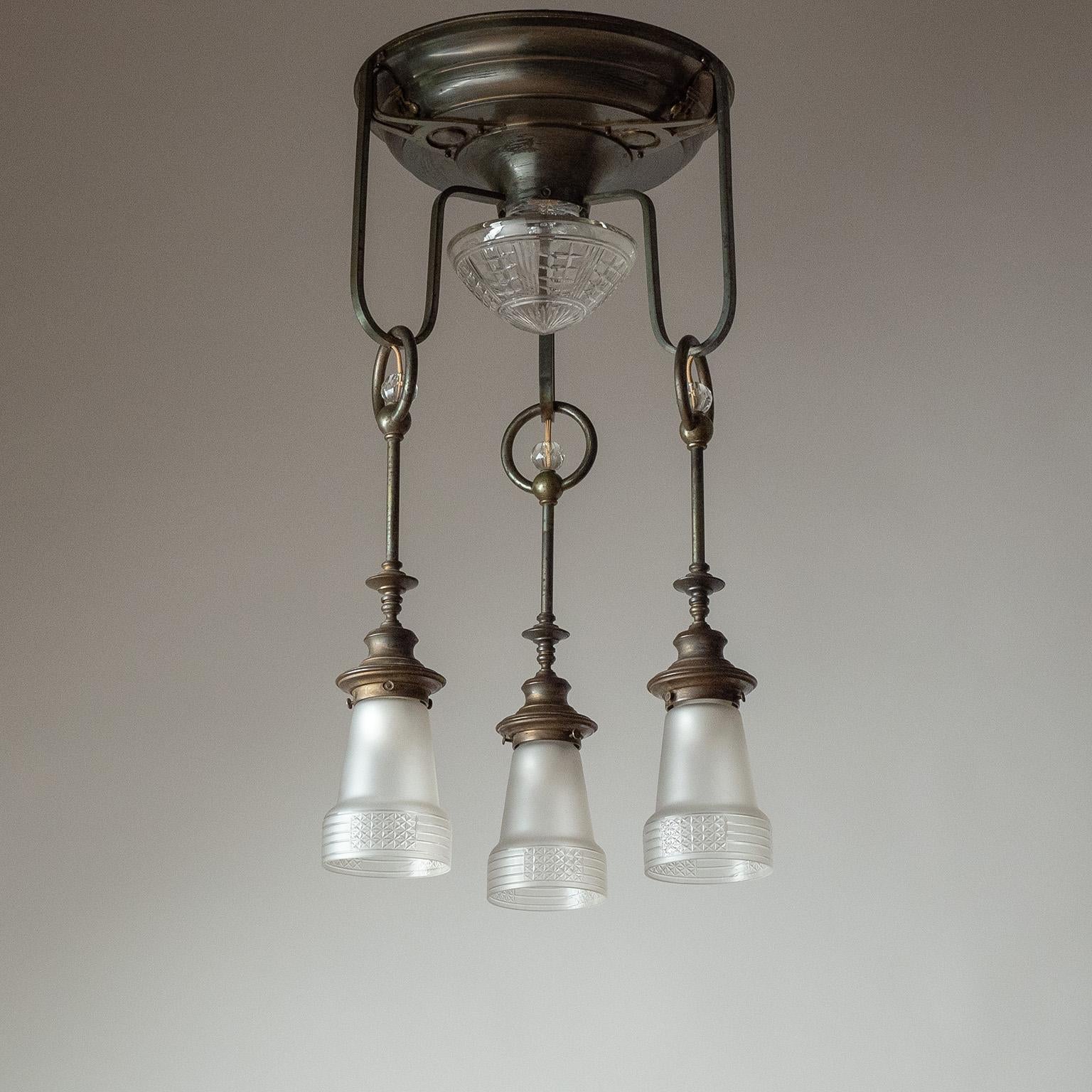 Rare Austrian Jugendstil ceiling light from the early 20th century. Unique brass construction with cut glass diffusers – the central, top one being clear, while the three ‚hanging‘ glasses are acid-etched for a satin finish. All glasses have