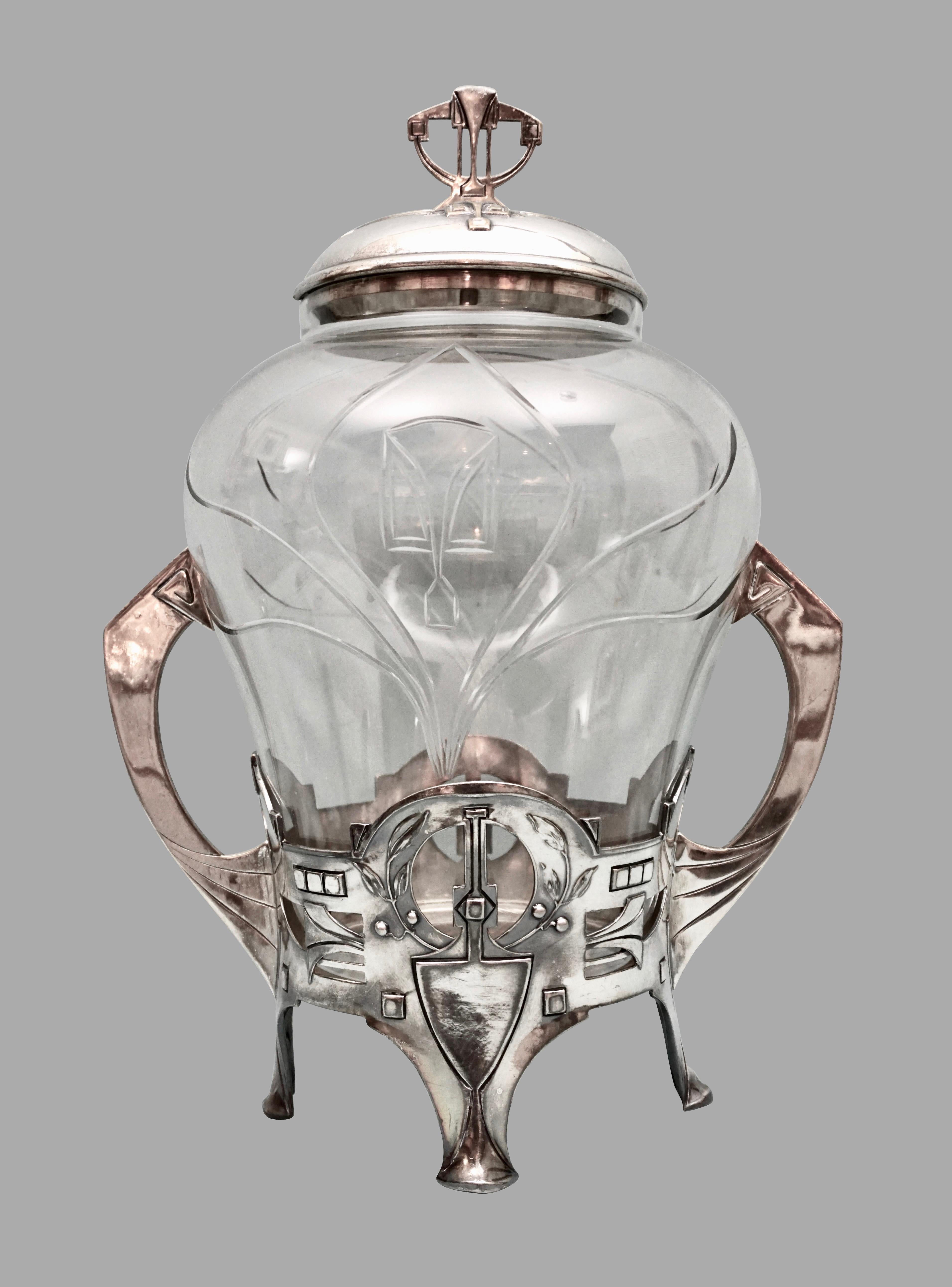 A German Jugendstil cut glass punch bowl, probably by Kayser, supported in an elaborate silver plate frame complete with its apparently original ladle with a gilded bowl. Jugendstil translates to 