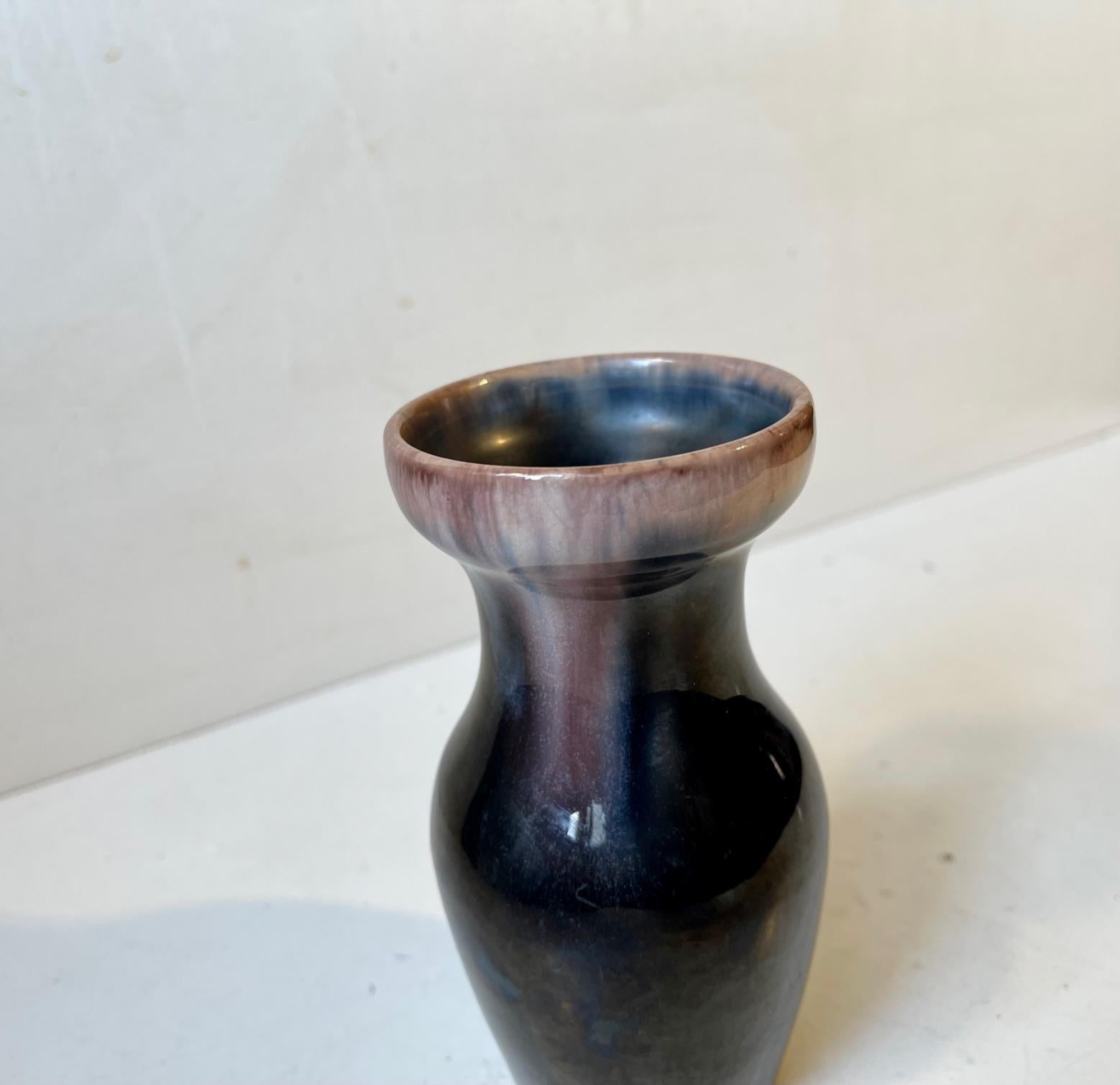 Early Danish Pottery vase with subtle Art Nouveau/Jugend styling and shape. Unusual plum and bone-toned glazes fading from the top down its sides. Designed and made by Michael Andersen & Son in Denmark between 1910-20. Originally intended as a