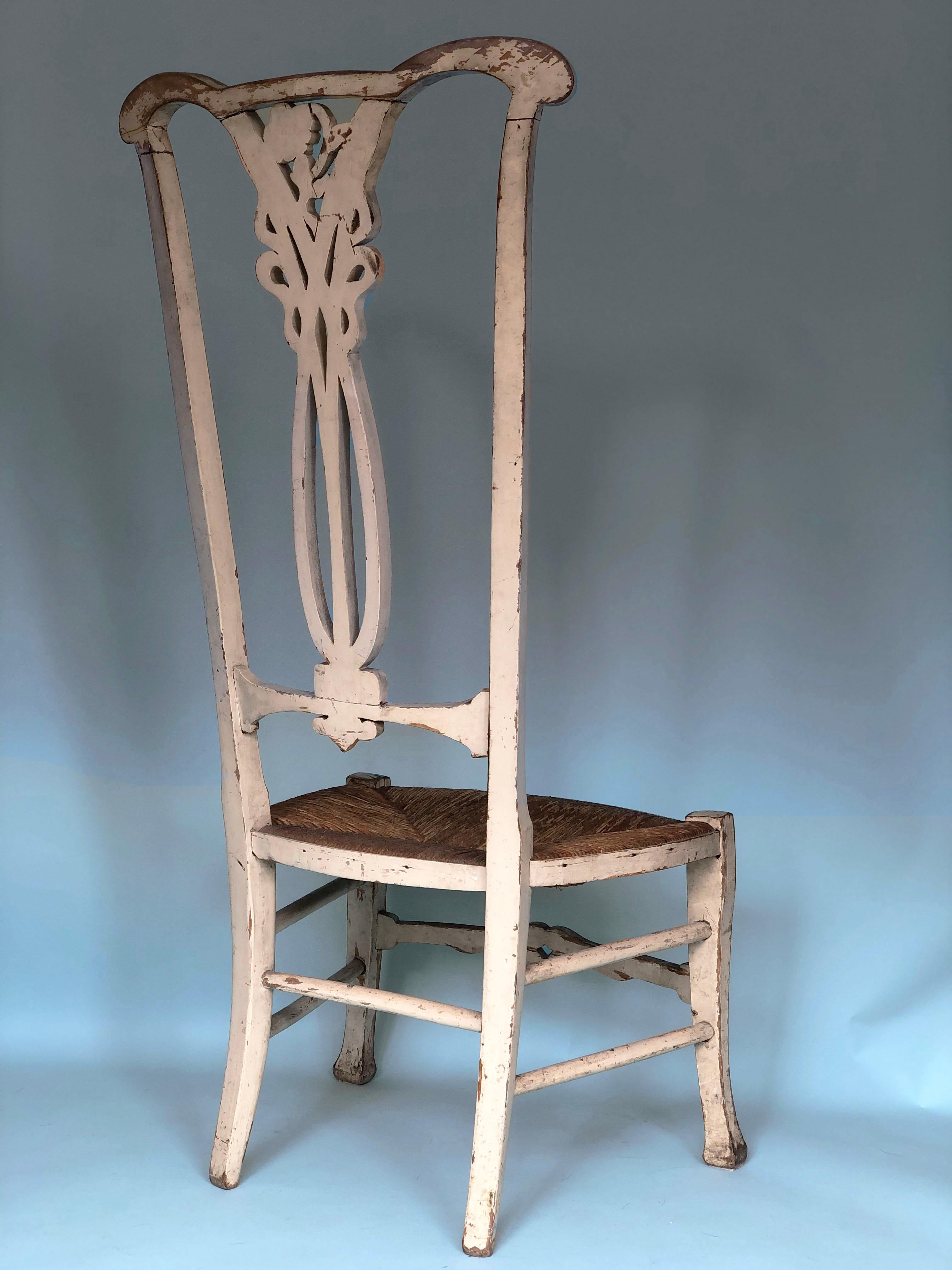 A cream painted high back chair from the Jugendstil period, Germany. The beautifully weathered chair with a carved back with a rush seat is in good condition.

Object: Chair
Design: Unknown
Style: Antique, Jugendstil
Period: 1890-1910
Country of