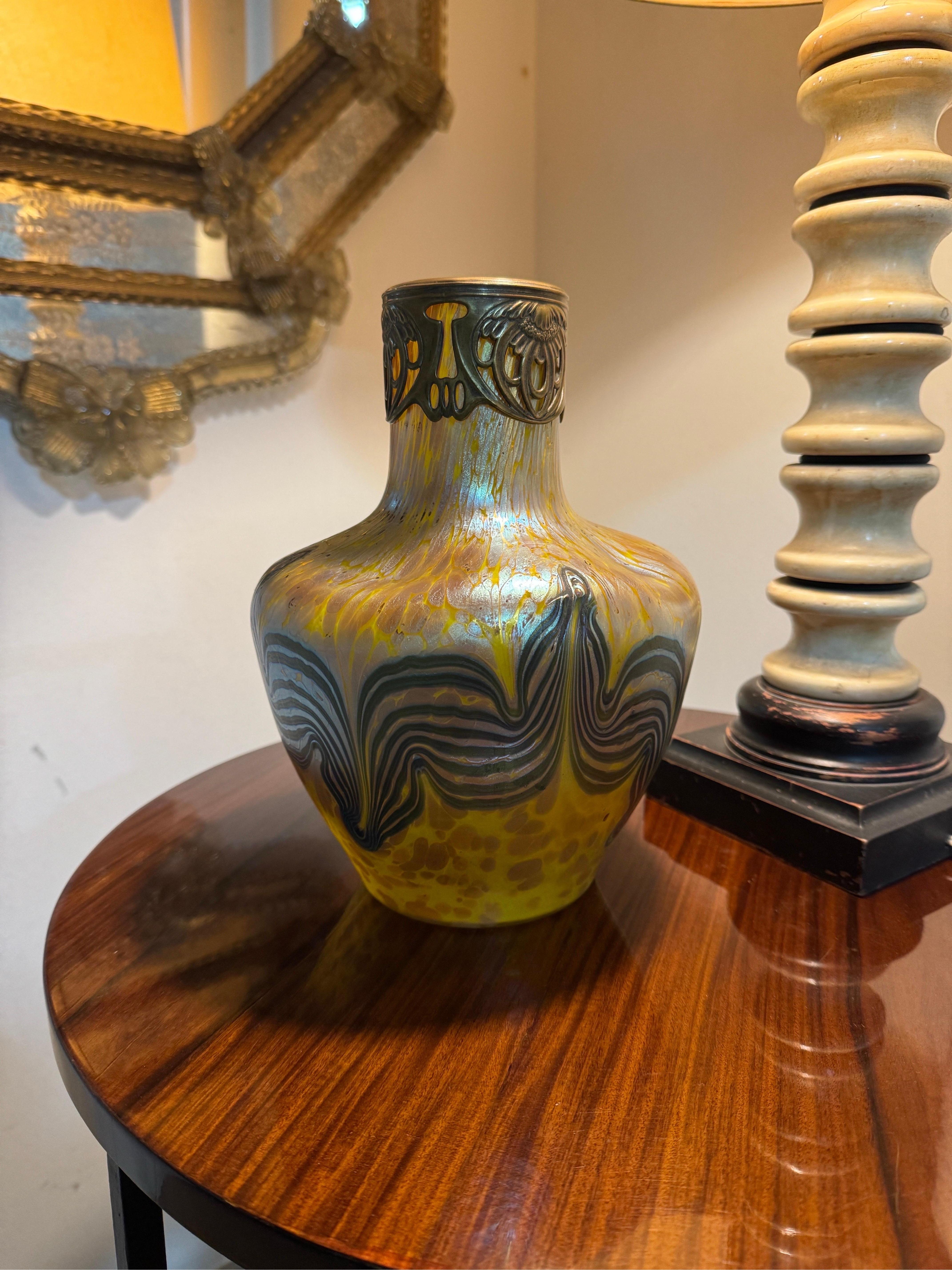 Jugendstil LOETZ vase; Austria, ca. 1900.
Iridescent blown glass.
An iridescent blown glass vase from the Austrian manufactory of Loetz, designed by Franz Hofstoetter, with a conical body with indentations at the top, neck and circular mouthpiece.