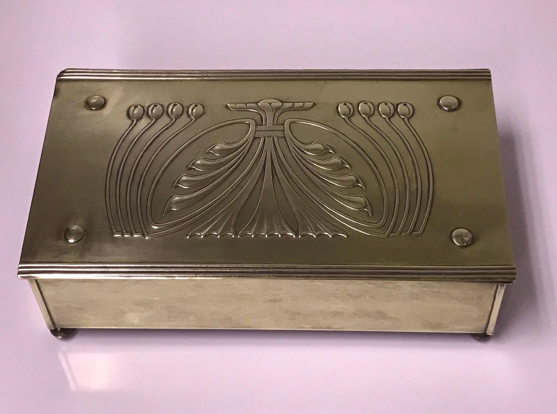Jugendstil Nouveau secessionist brass box, Carl Deffner Germany, circa 1910. The large rectangular box on four bun supports, stylized foliate hinged cover, plain sides. Cedar lined interior. CDE mark on underside. Measures: 9.125 x 5.25 x 2.60