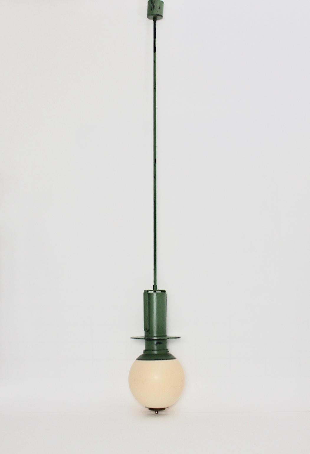 A very rare pendant or hanging lamp by Otto Wagner, Vienna, which was designed for the Viennese Stadtbahn, circa 1898 in Vienna. The hanging lamp was made out of the typical reseda green lacquered metal and brass and a plastic lamp shade with an E