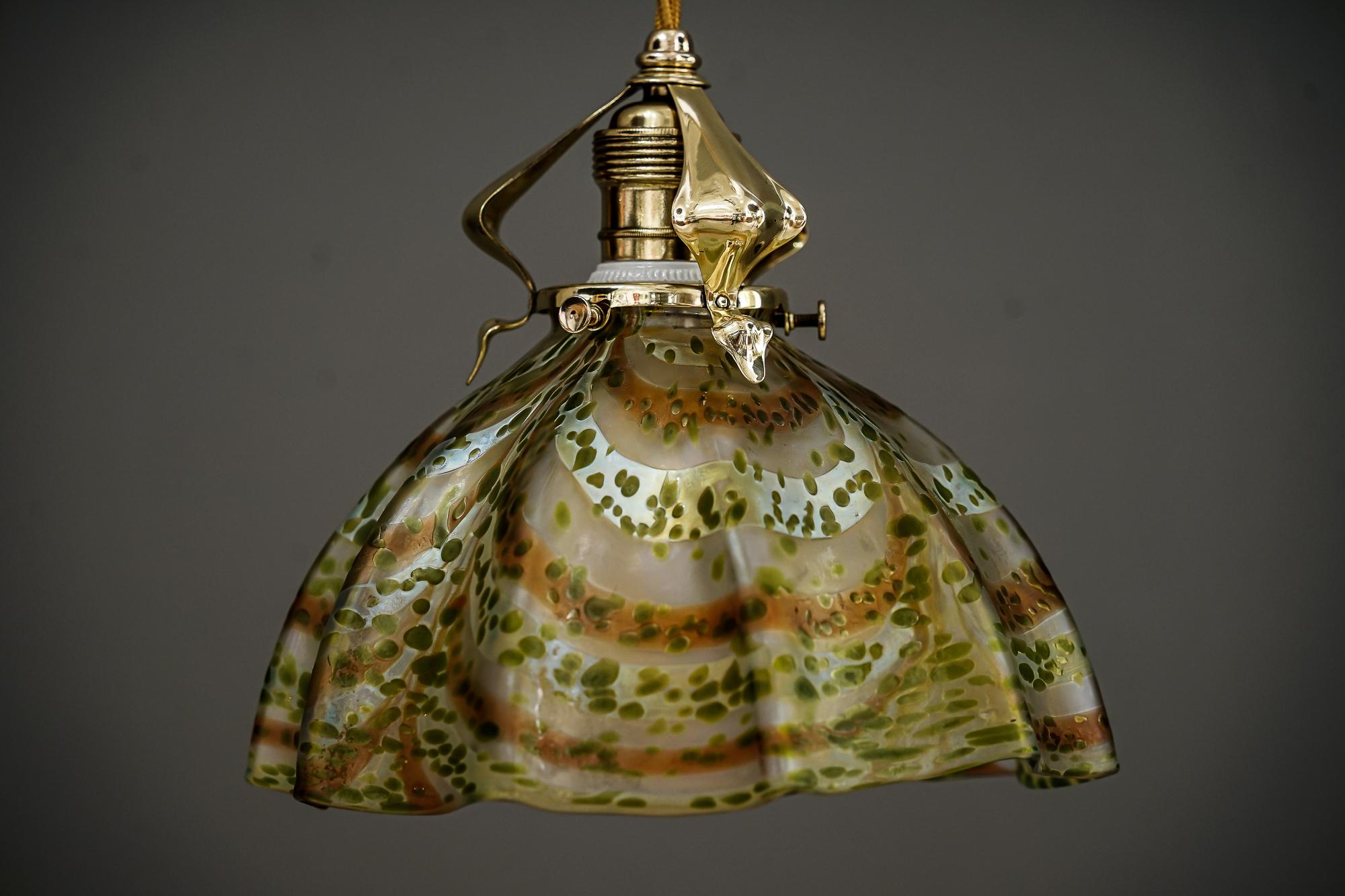 Jugendstil Pendant vienna around 1907 with loetz glass shade
Brass polished and stove enameled.
  