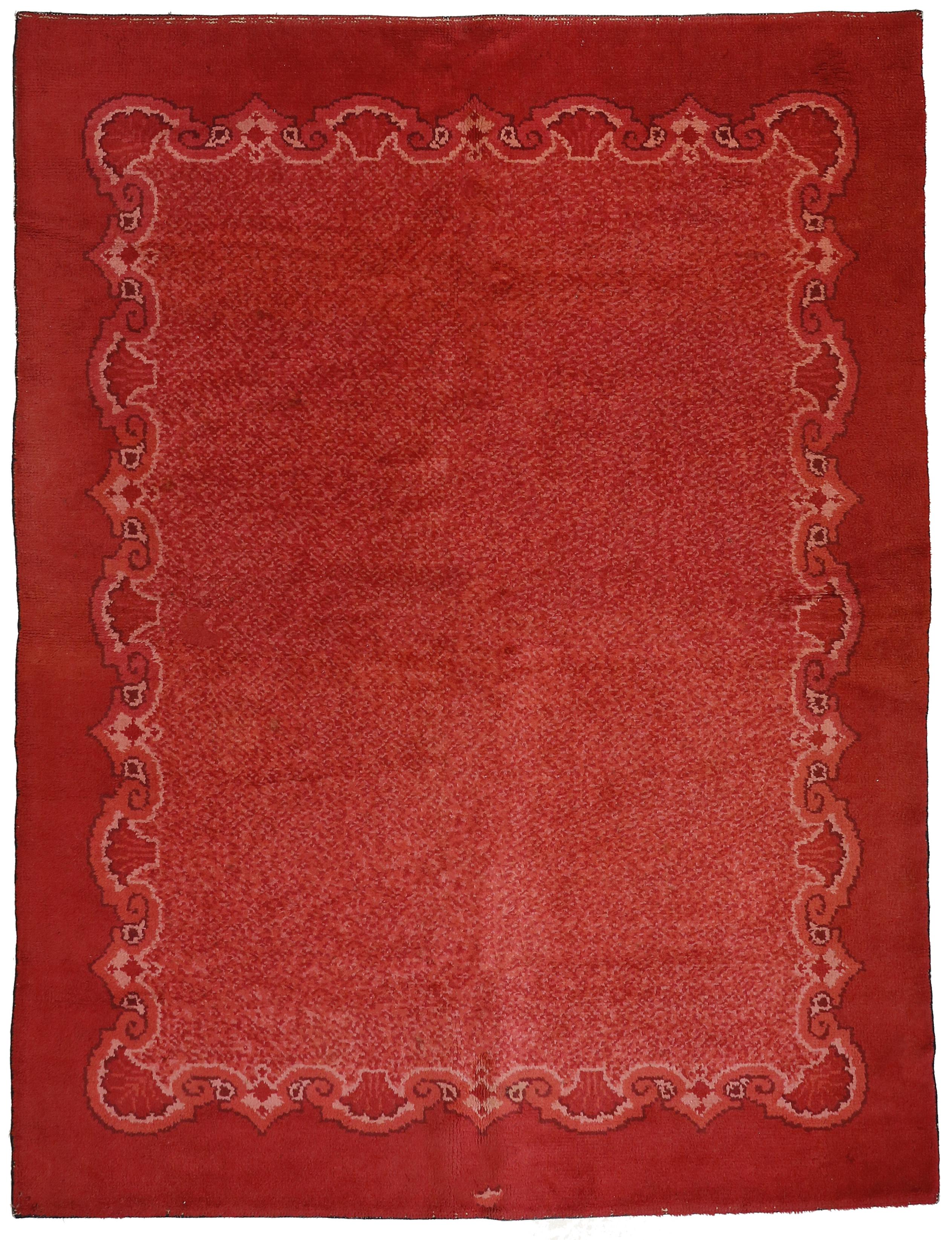 A rare and unusual Austrian carpet decorated in the typical Jugendstil manner, with a 'salt and pepper' red background obtained by mixing red yarns of different tonalities and with a curvilinear border characteristic of the carpets of the Art