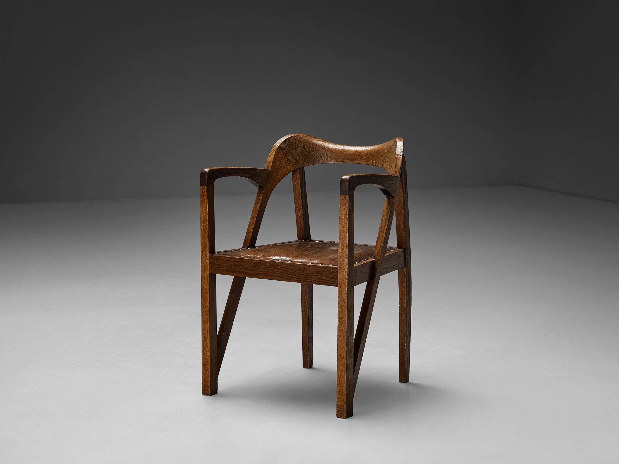 Armchair, oak, leather, brass, Europe, 1900-1910

This meticulously crafted armchair is created between 1900 and 1910 and stands as an embodiment of the Jugendstil movement’s ideals. The chair has many wonderful features, to start with the diagonal