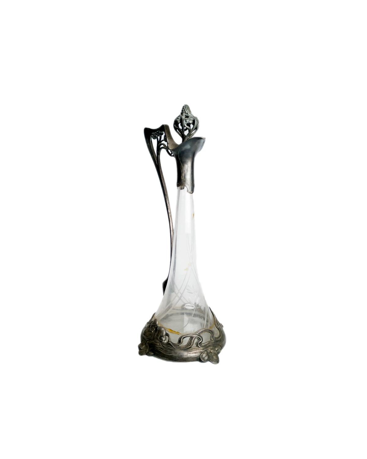 An antique Jugendstil style Lady Glass Claret Jug Decanter with refined plug, a WMF designed, glass and silver plated.
An excellent example of Art Nouveau Design with vine decoration in the metal. 
