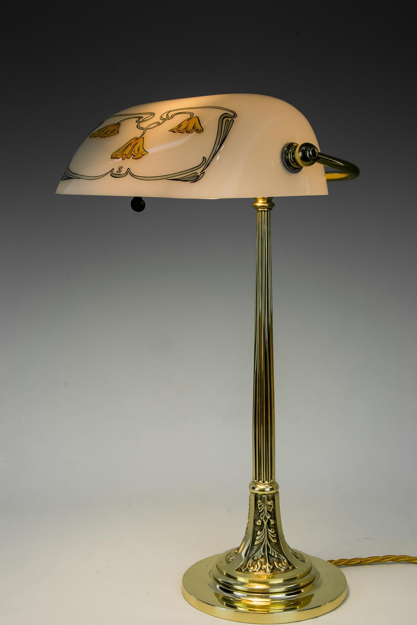 Jugendstil table lamp with new glass shade, Vienna, circa 1908.
Brass polished and stove enameled.