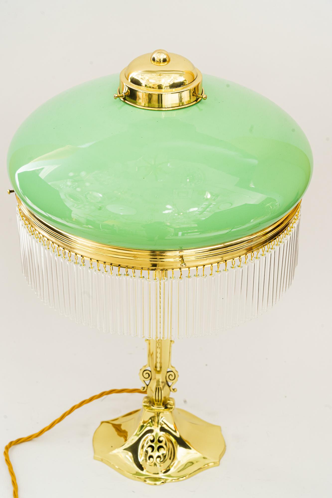 Jugendstil Table lamp with opal glass shade and glass sticks vienna around 1910s
Brass polished and stove enameled
Original opal glass shade
The glass sticks are replaced ( new )