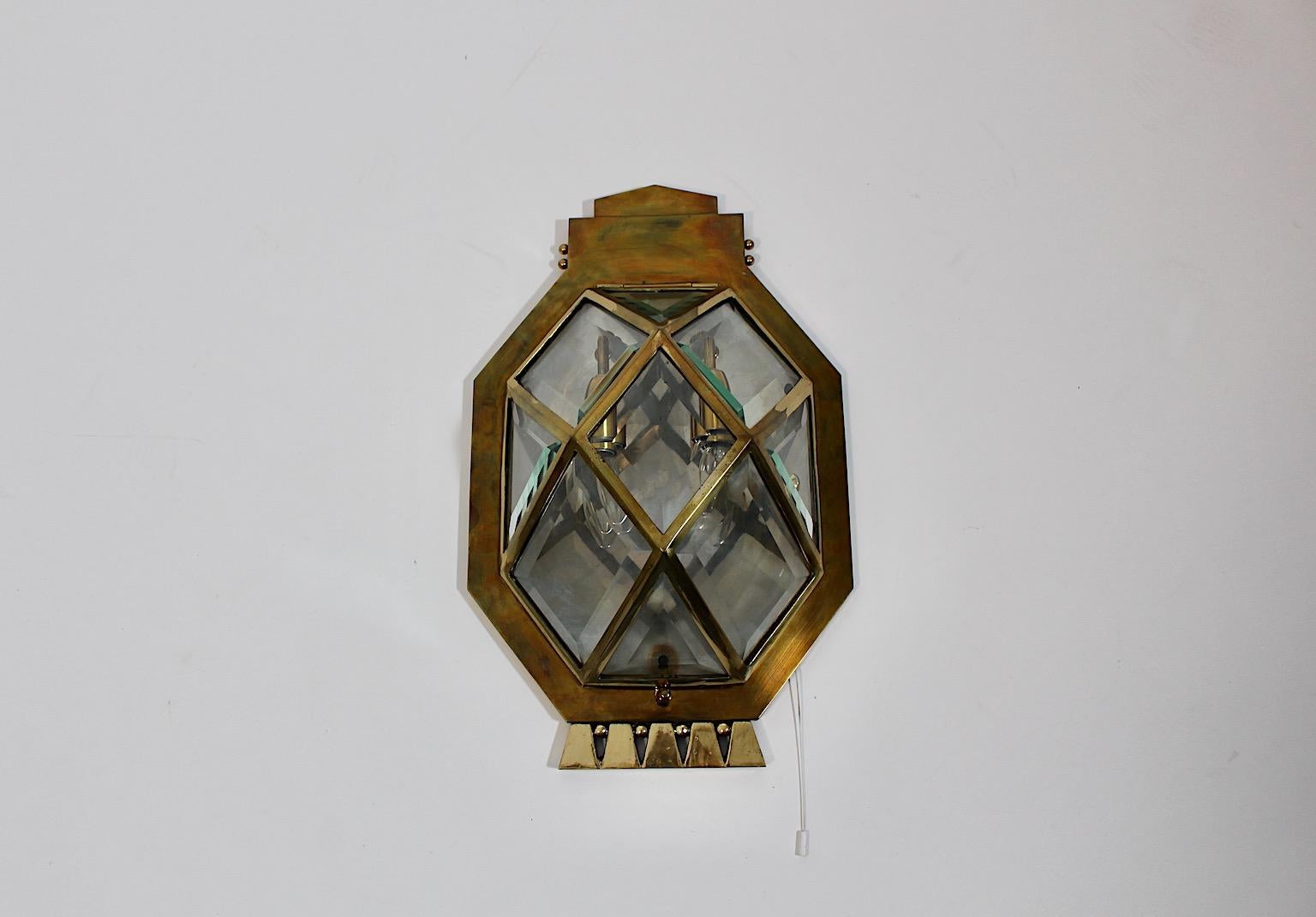 Jugendstil Vintage Sconce or Wall Light from brass and facetted clear glass circa 1910 Vienna.
A beautiful sconce from brass and facetted glass in rhomboid geometric shape.
This sconce shows two E 14 sockets. The shade is easily to open and to close