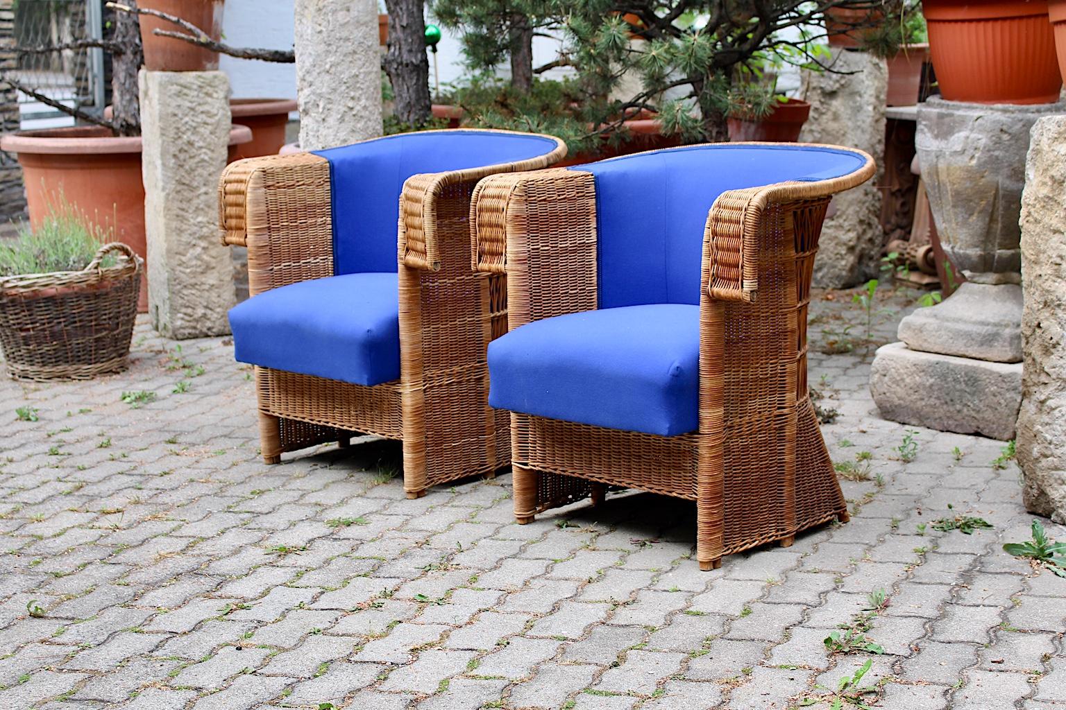 Jugendstil vintage rattan armchairs, which were designed by Hans Vollmer, 1902-1903, Vienna and executed by Prag - Rudniker Korbwaren Fabrication. 

This set of 2 luxurious Jugendstil rattan armchairs are reupholstered and covered with a