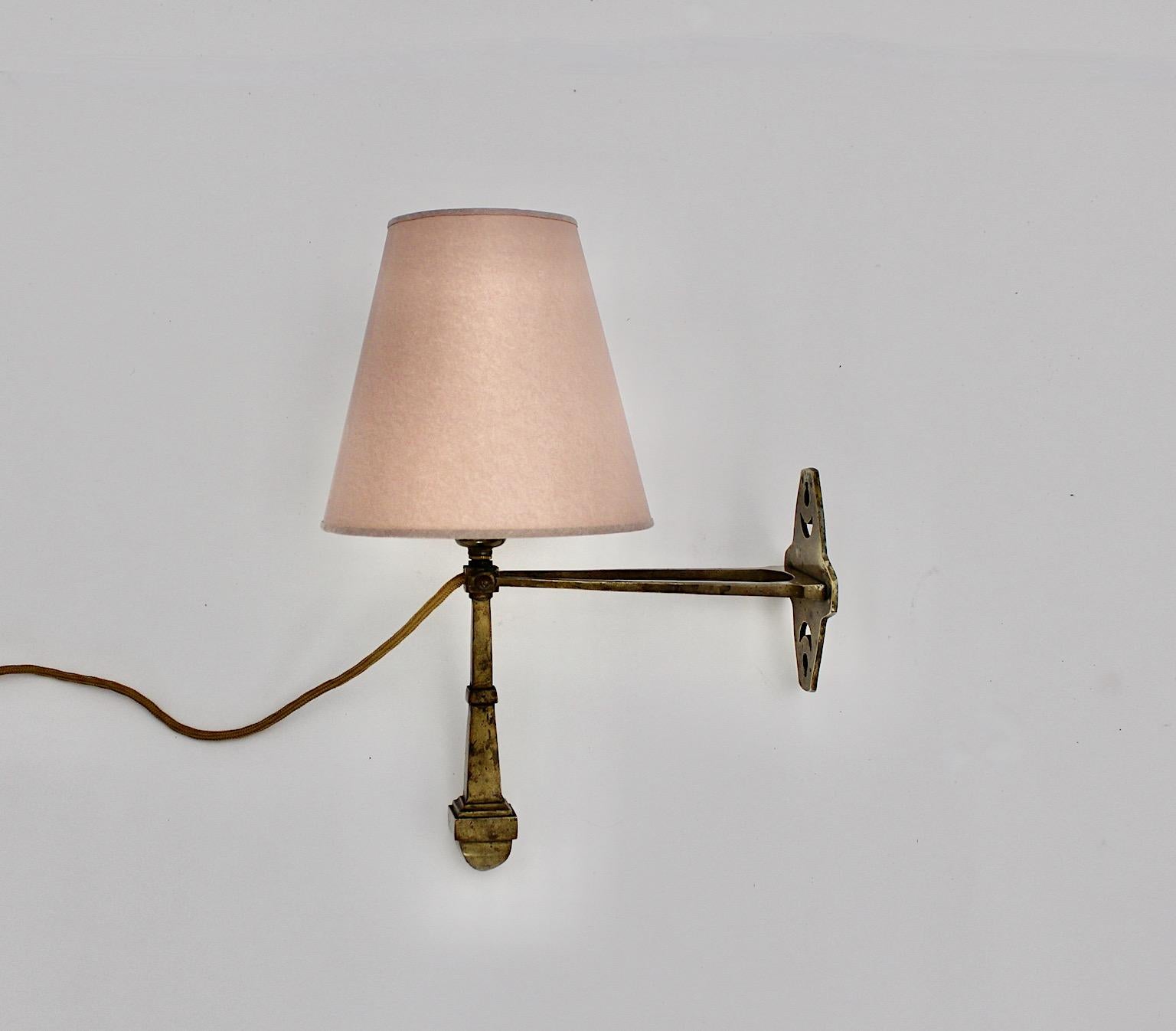Jugendstil vintage table lamp or wall light from solid brass with a new paper shade in dusty pink circa 1910 Austria.
An amazing table lamp or sconce from solid brass in beautiful golden tone with brass patina topped with a new adjustable lamp