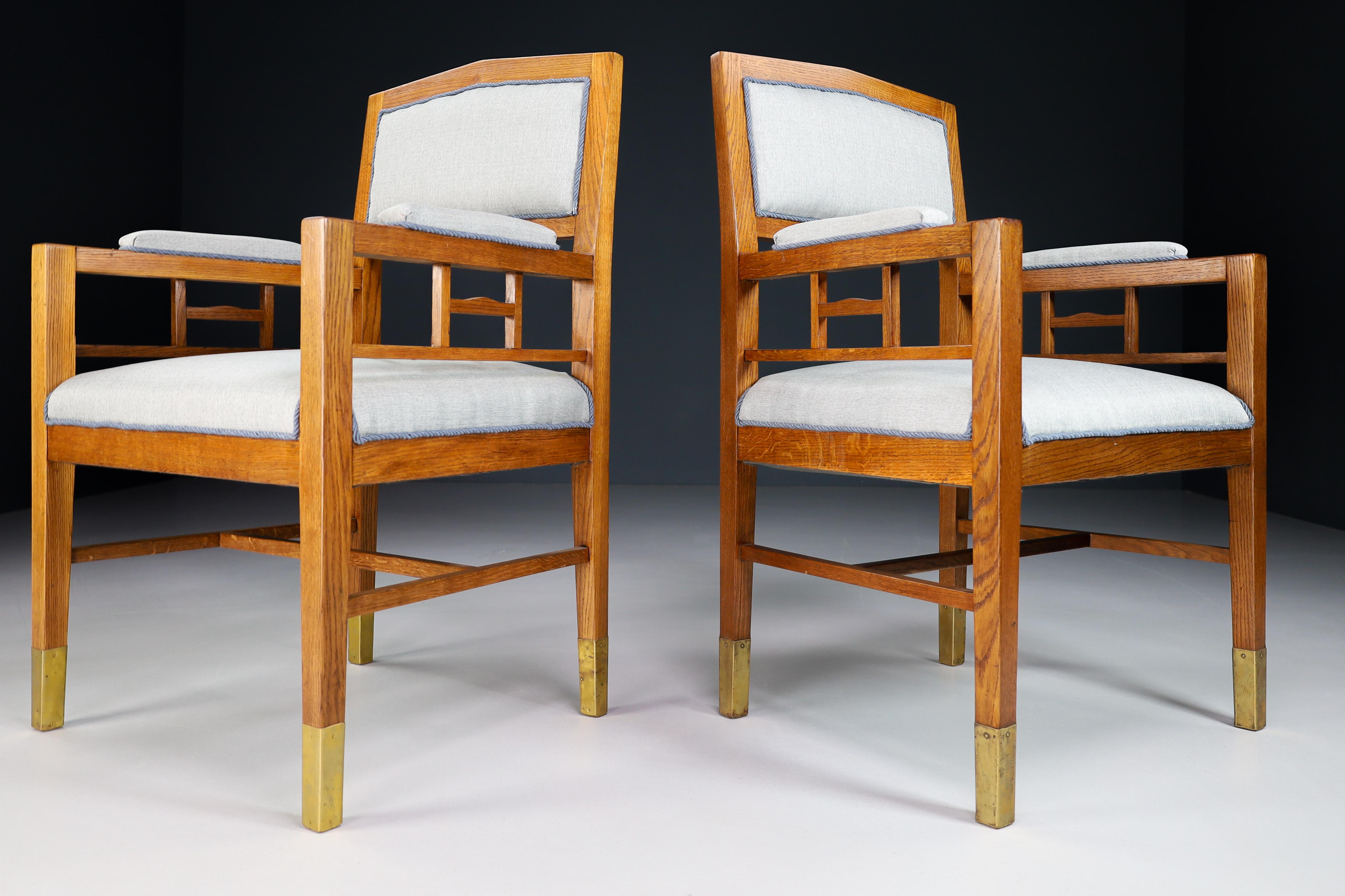 Pair of two Jugendstil / Art-Deco lounge / arm chairs, in Oak and Re-upholstered fabric, Austria 1920s. These armchairs would make an eye-catching addition to any interior such as living room, family room, screening room or even in the office. It