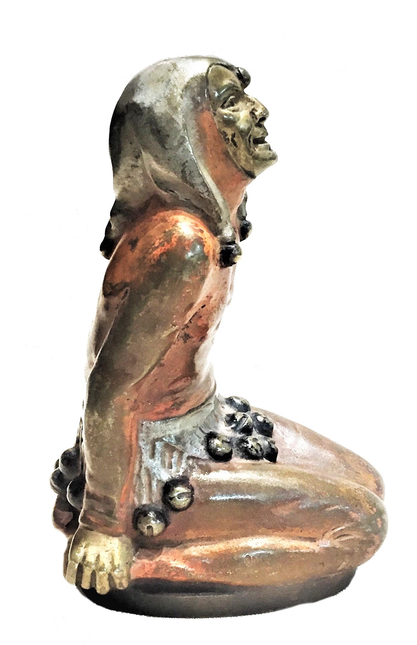 Dimensions: 4.33 high x 2.25 wide x 2.75 deep

This elegant desk-size statuette of a kneeled harlequin wearing a golden mask is a perfect example of the little masterpieces in cold-painted bronze, created in Vienna around 1900; during the