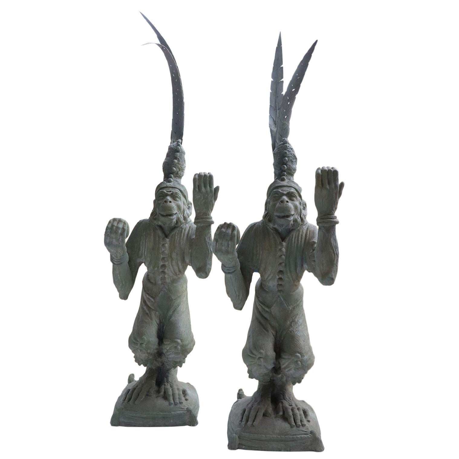 A pair of playful juggling monkeys made of resin. Resting upon a sturdy base measuring 14.5